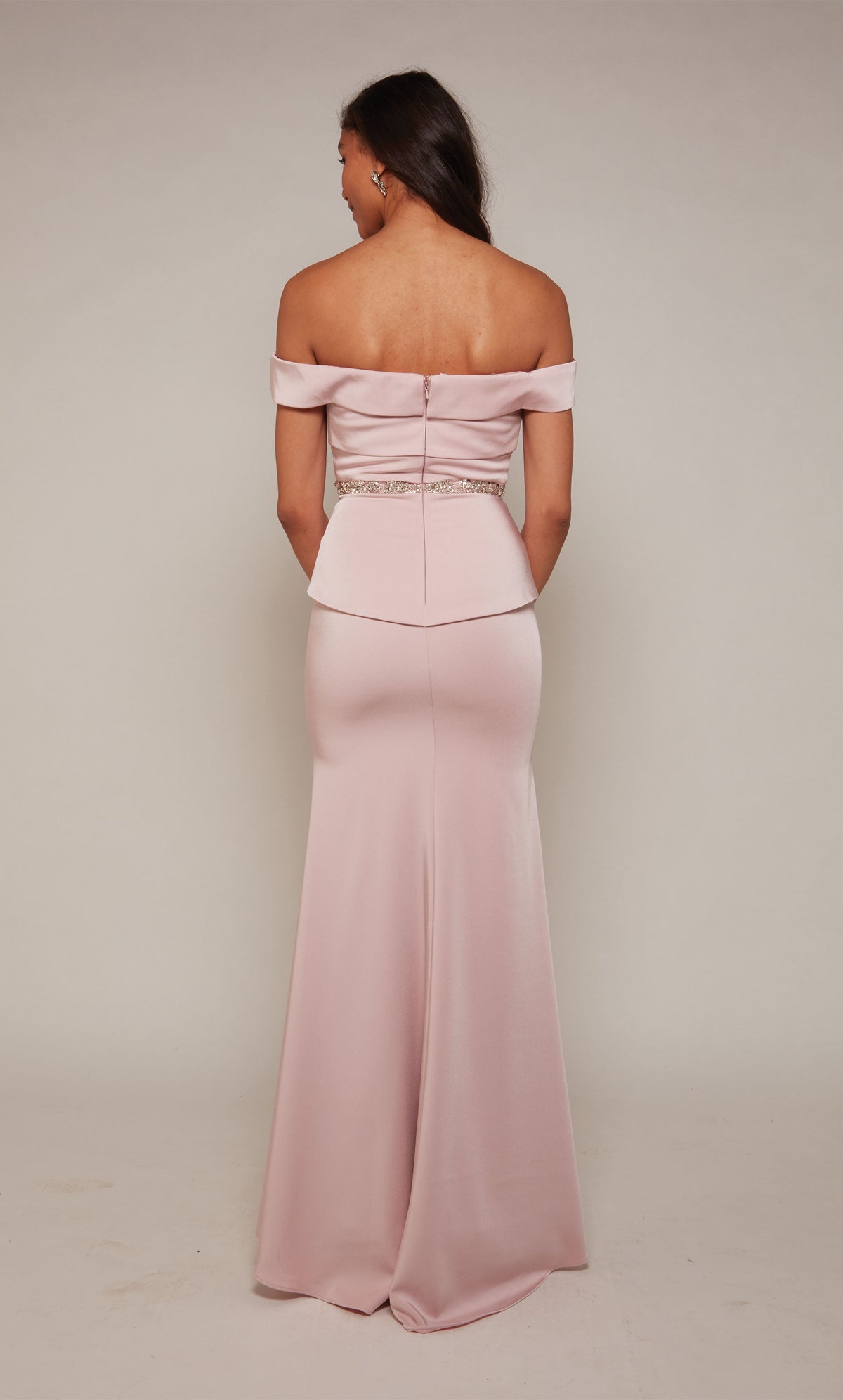 Rosewood colored, off the shoulder designer gown with an closed zipper back, beaded waist, and slight train.