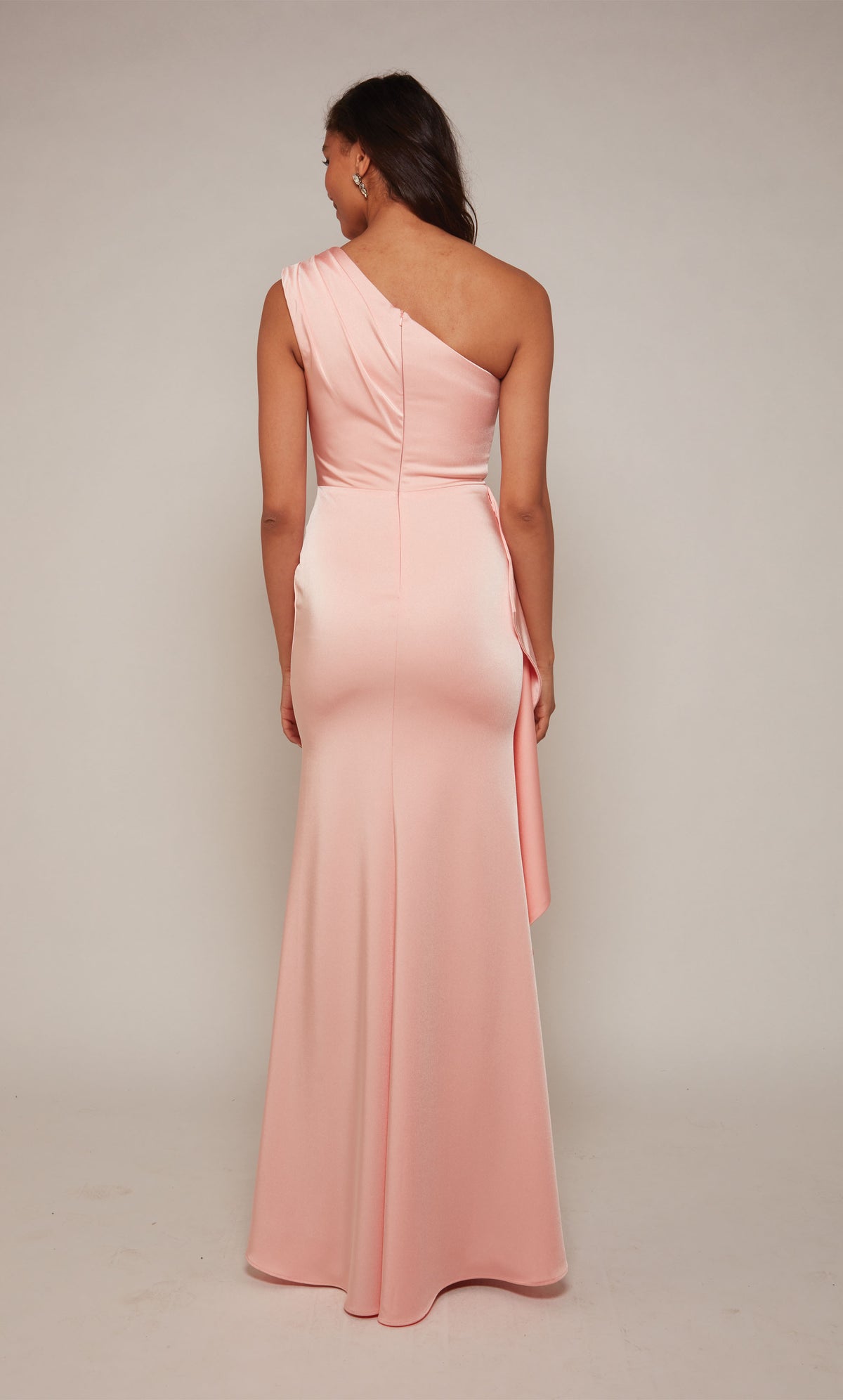 Long one shoulder side ruffle gown with ruching detail, an closed back, and train.