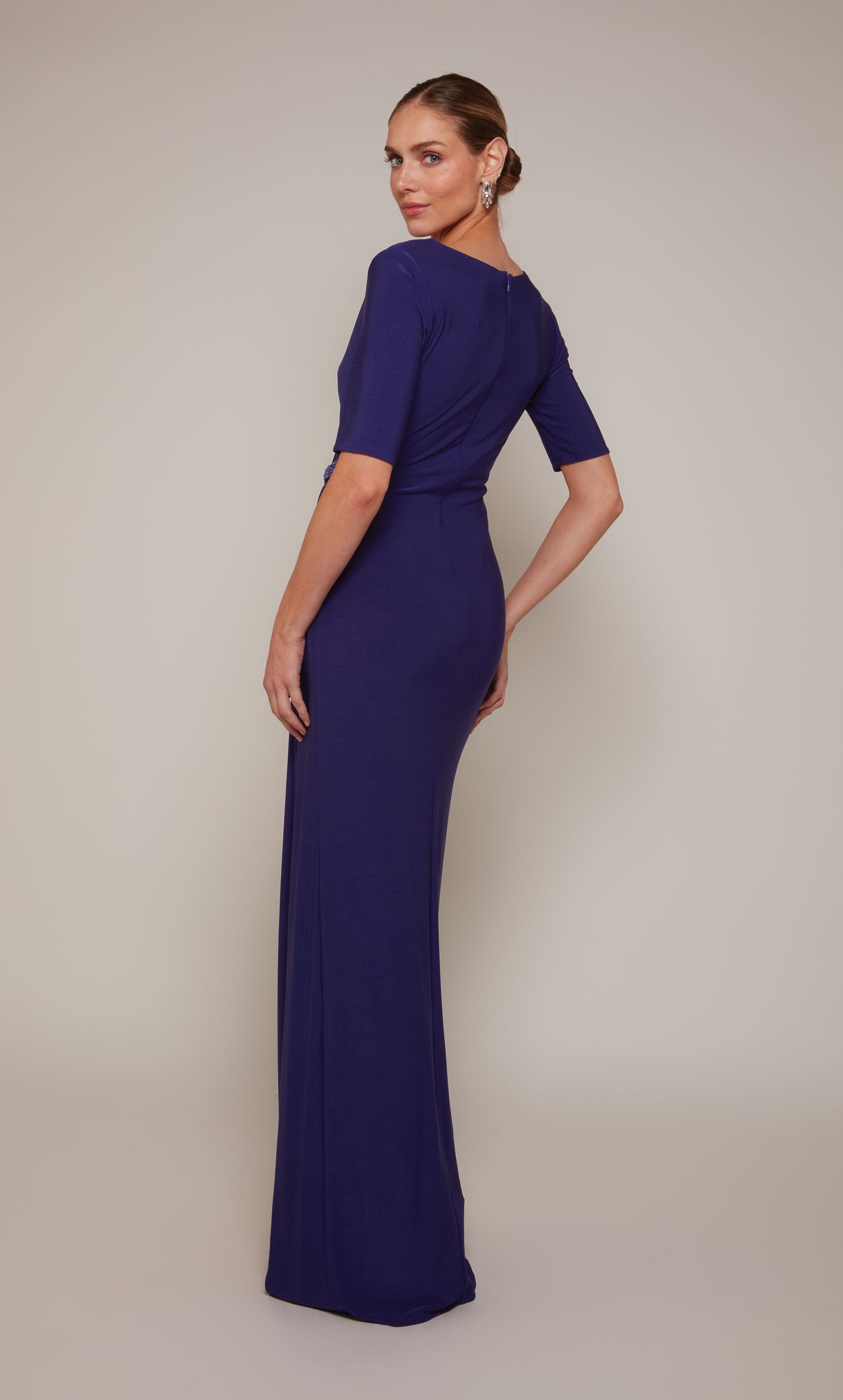 A ruched wedding guest dress with a V-neckline, short sleeves, and a side slit in royal blue.