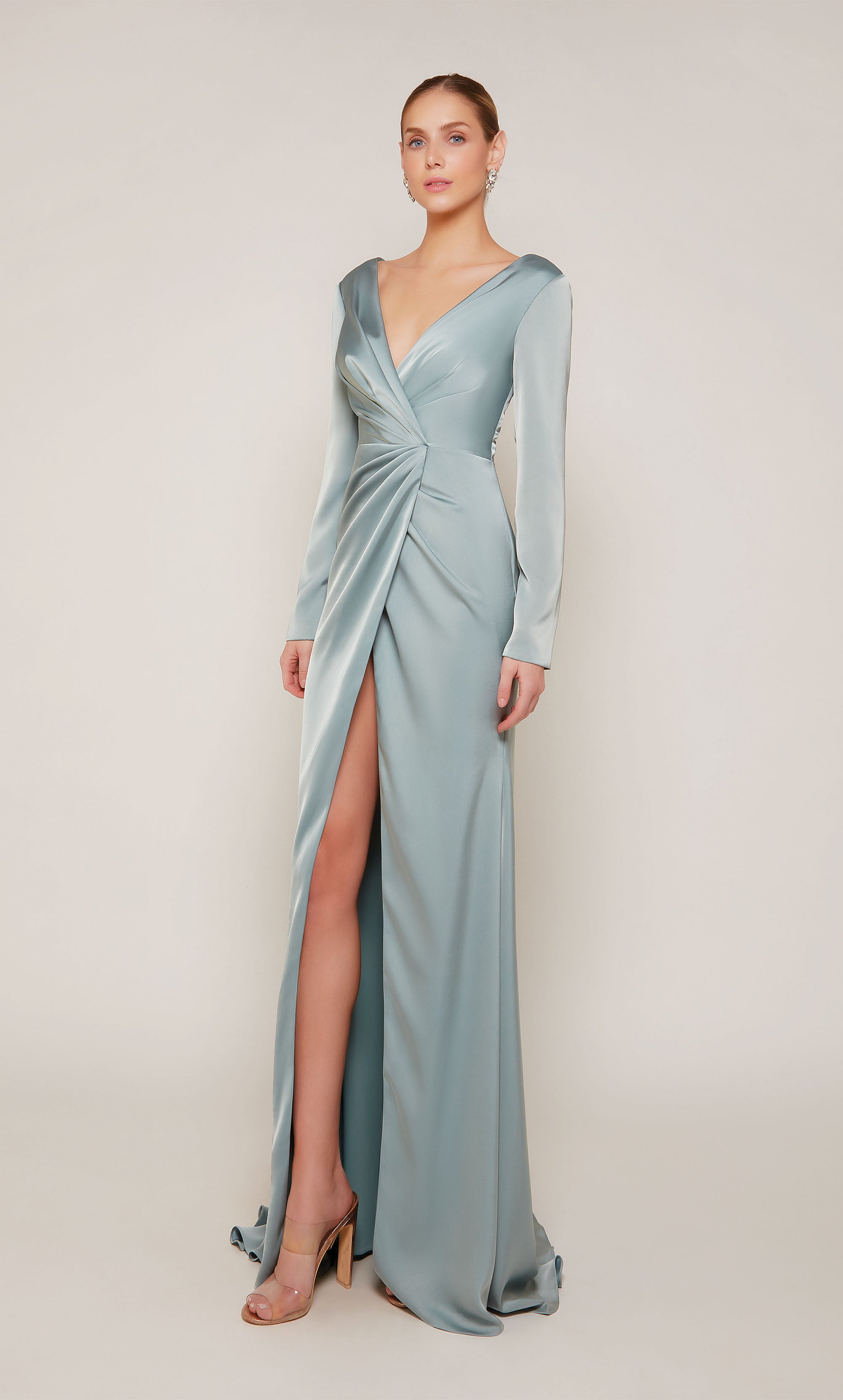 A chic, long sleeve evening gown with a low V-neckline and front slit in a sheen french blue color.