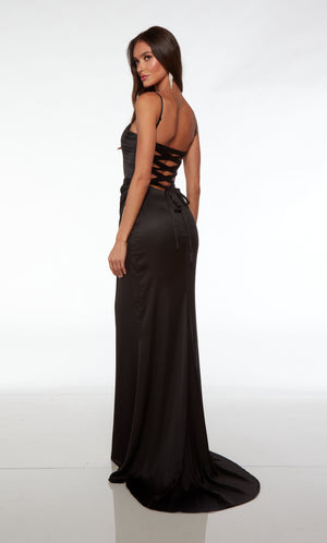 Glamorous black prom dress with an plunging corset top, silver rhinestone trimmed side slit, adjustable straps, lace up back, and train crafted in satin.