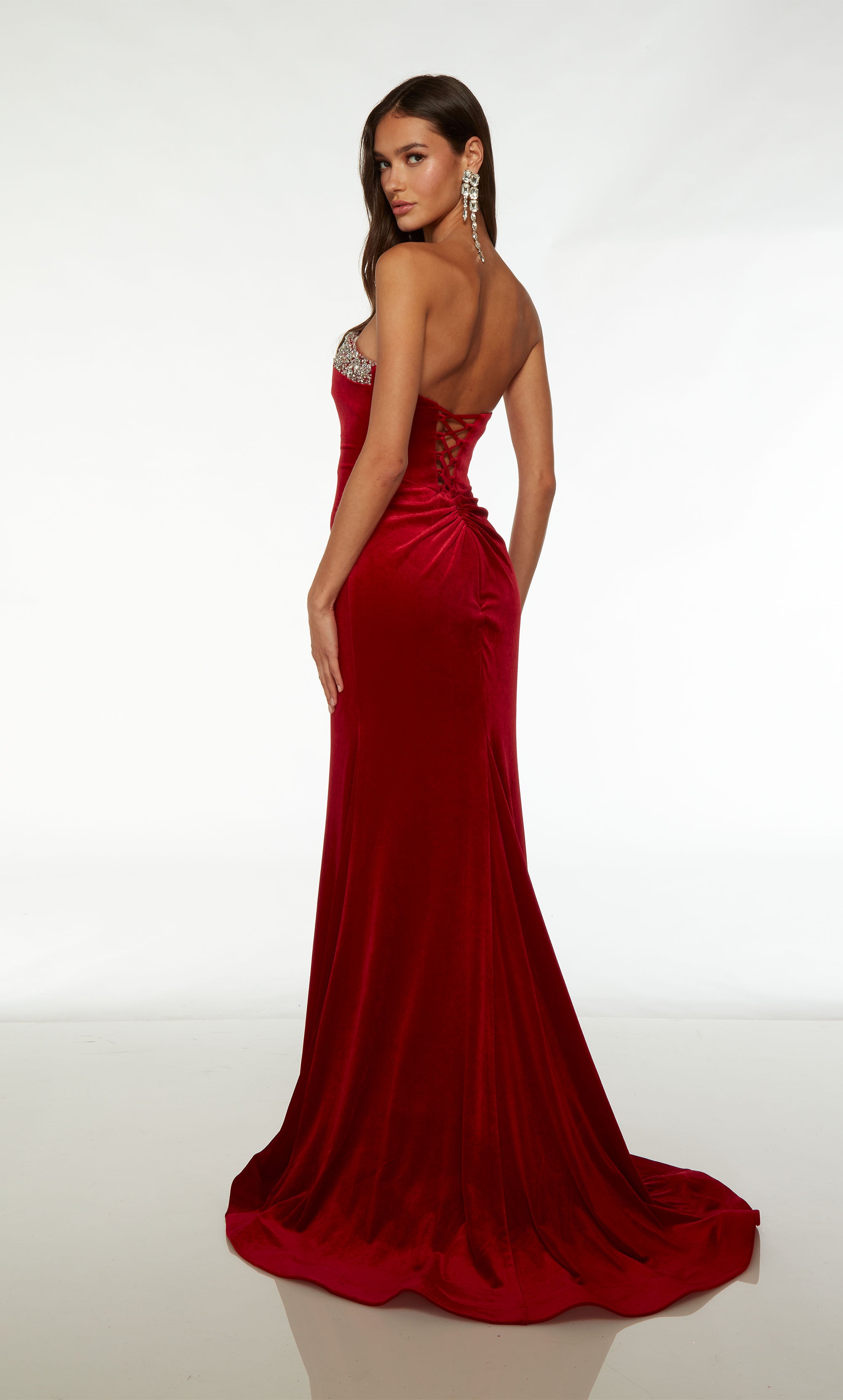 Red velvet fit-and-flare formal gown: Silver rhinestone-trimmed strapless neckline, lace-up back, and an beautiful train for an stunning and elegant look.