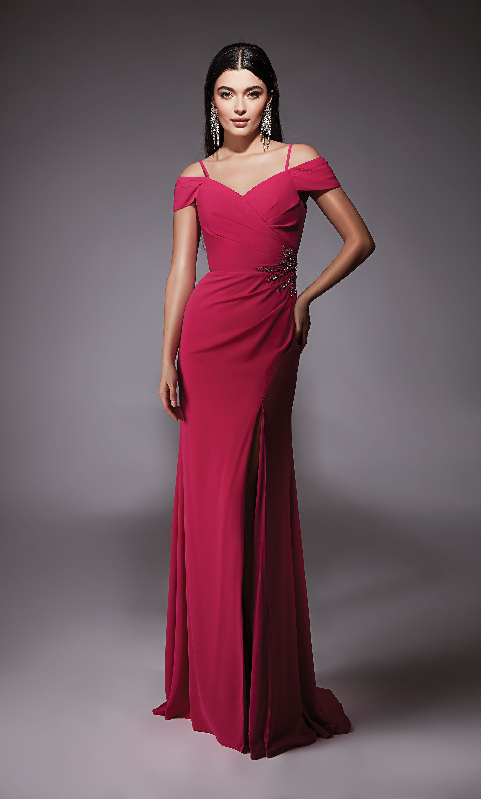 A hot pink, off-the-shoulder, mother-of-the-bride dress with adjustable spaghetti straps and a side slit. The back has a zip-up closure and a slight train.