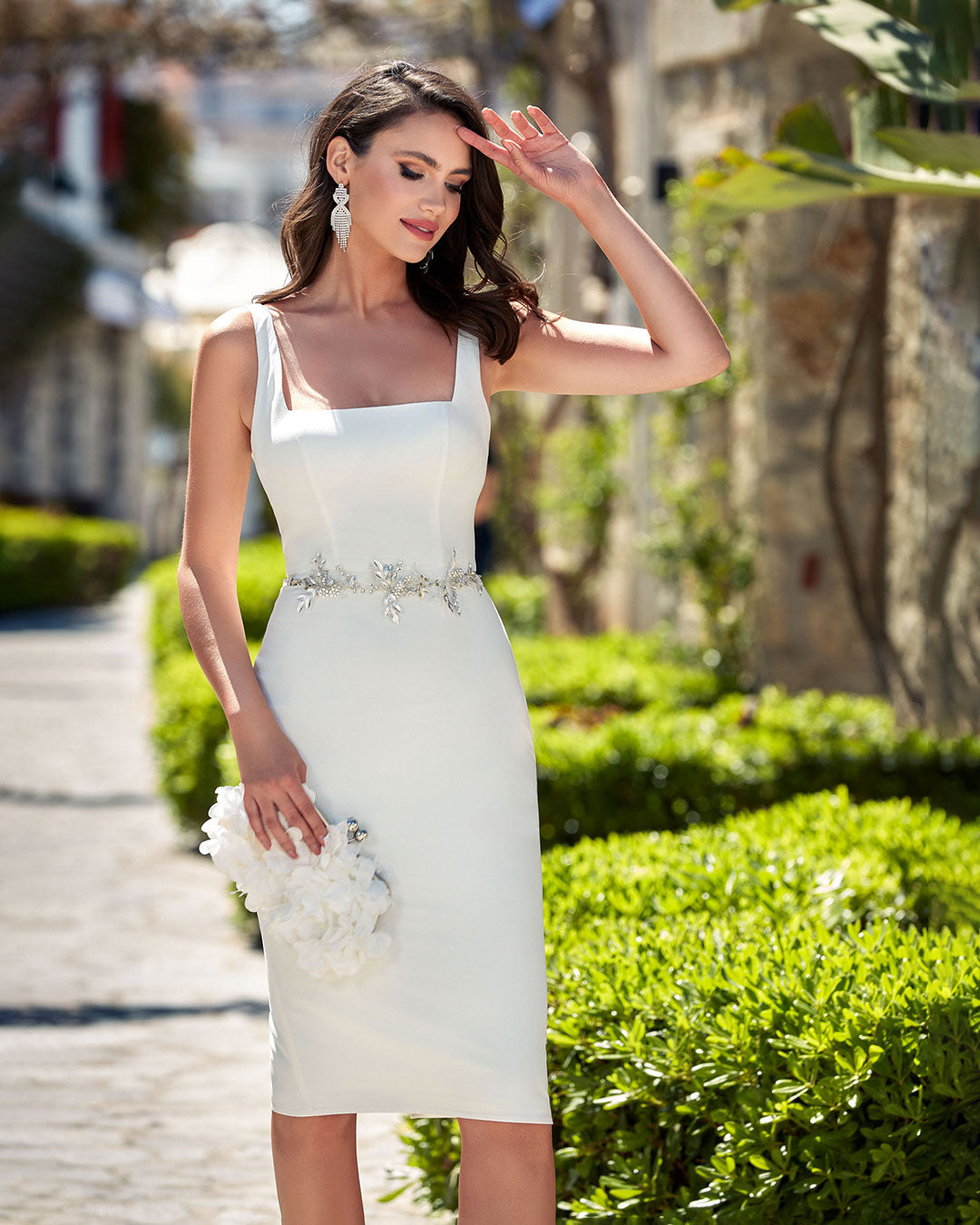 Ivory knee length engagement dress with a square neckline and thick straps.
