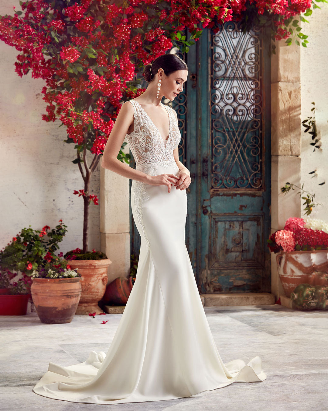 Simple wedding dress with sheer lace bodice and train in ivory.