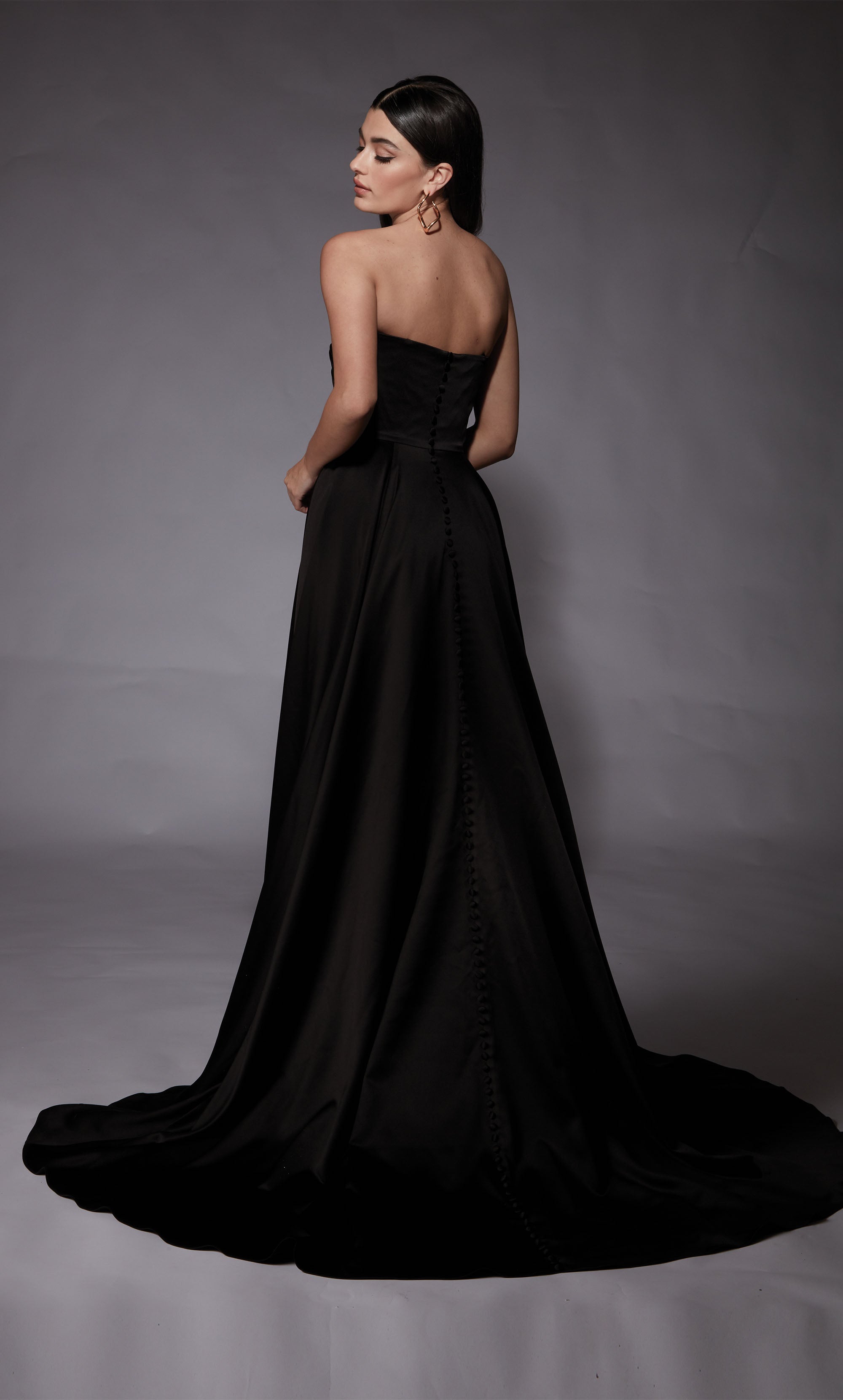 A-line satin bridal gown featuring a strapless, semi-sweetheart neckline, a pleated bodice, and high side slit in the color Black.