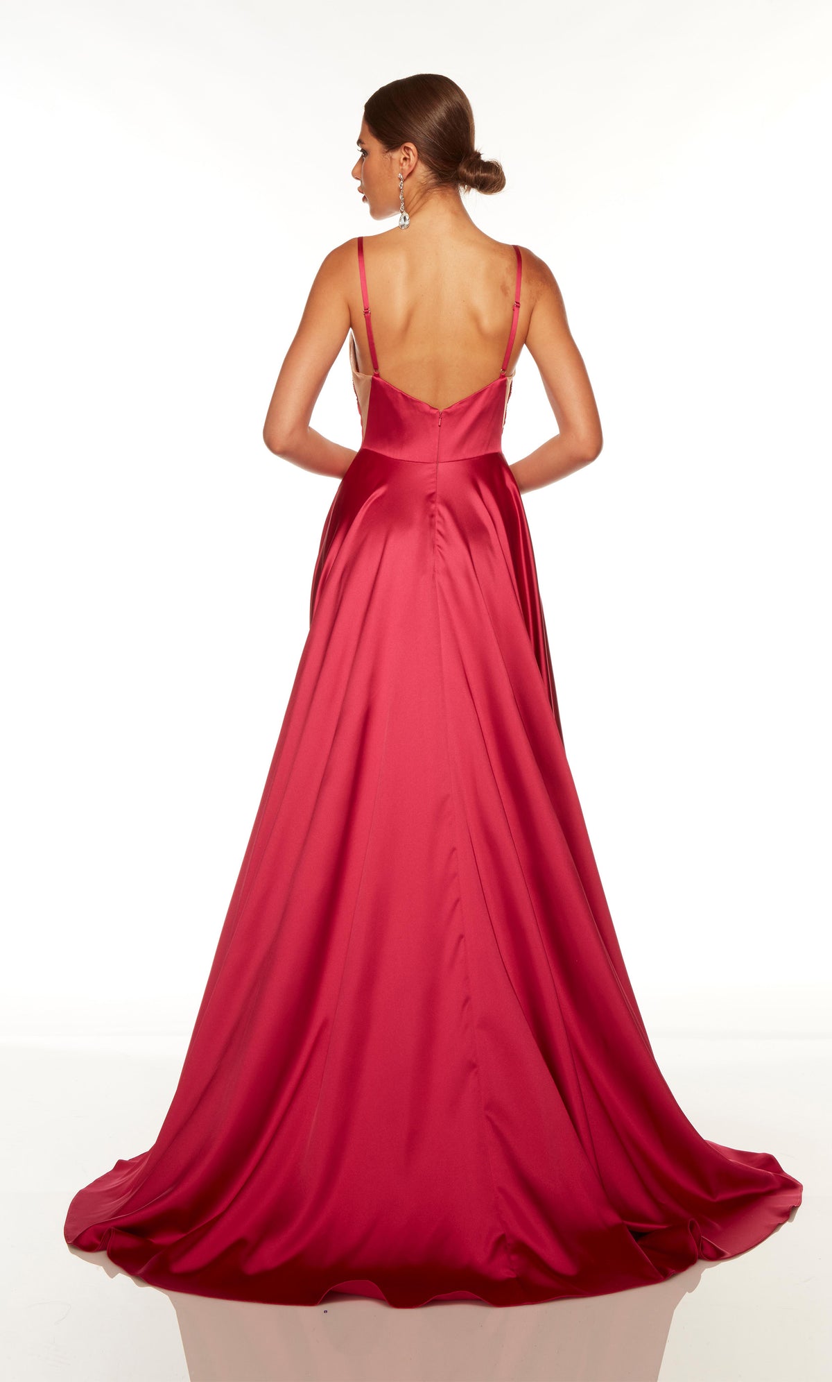 Flowy evening gown with a V back, sheer side cutouts, and train in fuchsia pink.