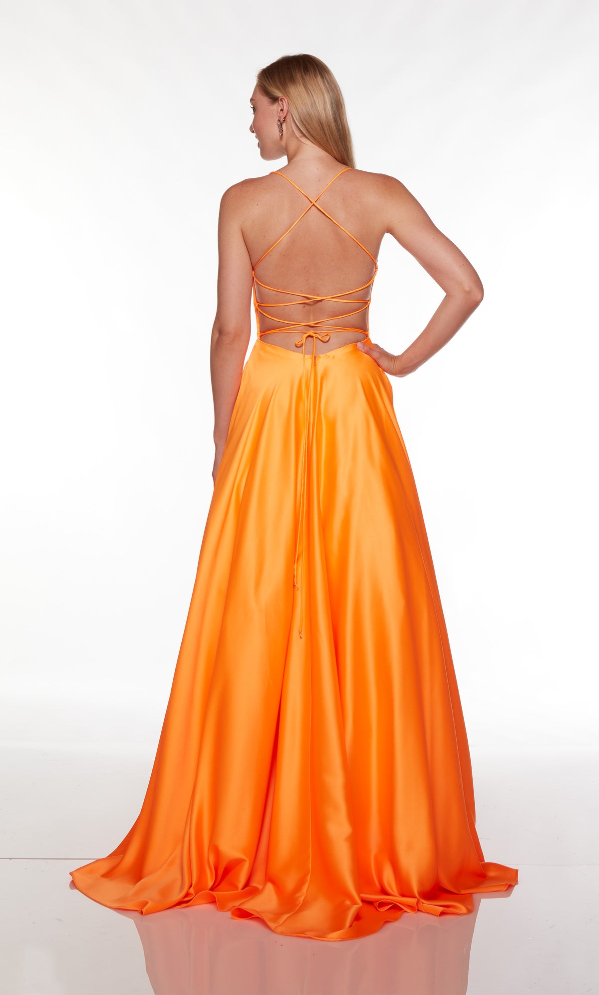 Long orange dress with a strappy, lace-up back and train.