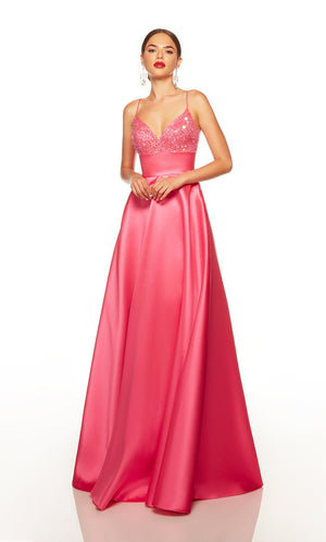 Long pink evening gown with a sweetheart neckline, beaded bodice, and pockets.