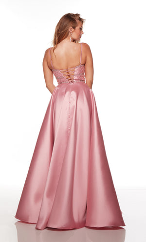 Plus size pink prom dress with a lace-up back, pockets, and adjustable straps.