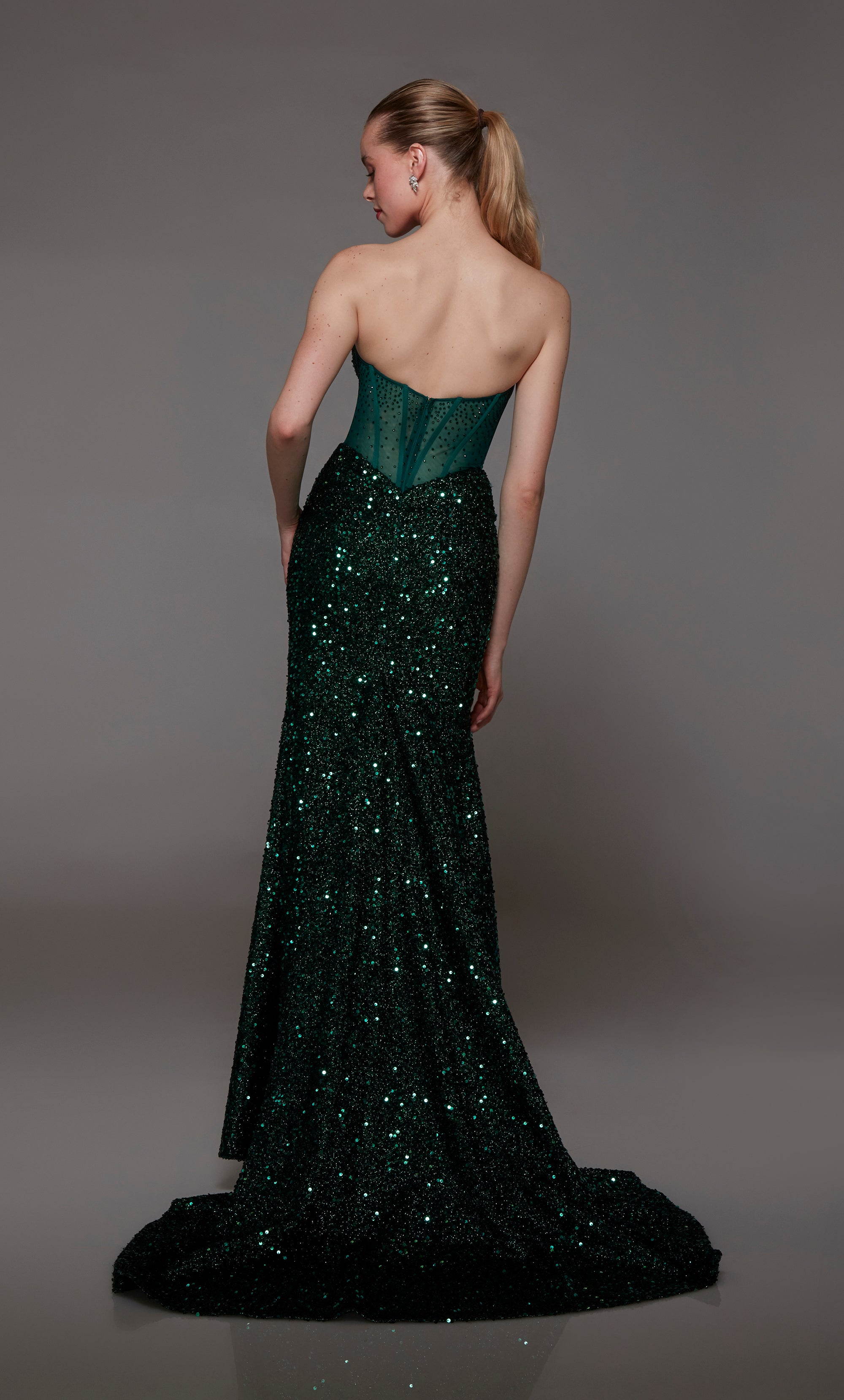 Captivating green strapless prom dress with intricate sequin detailing, corset bodice, alluring slit, and an graceful train for an red-carpet-worthy look.