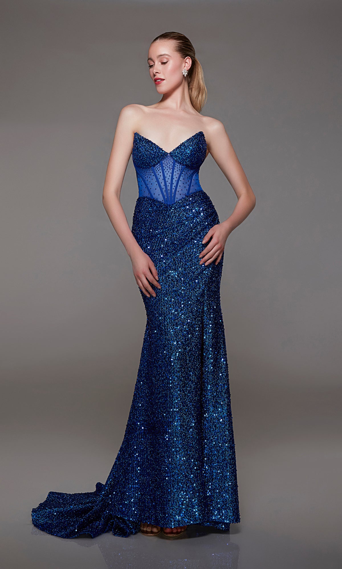 Captivating royal blue strapless prom dress with intricate sequin detailing, corset bodice, alluring slit, and an graceful train for an red-carpet-worthy look.