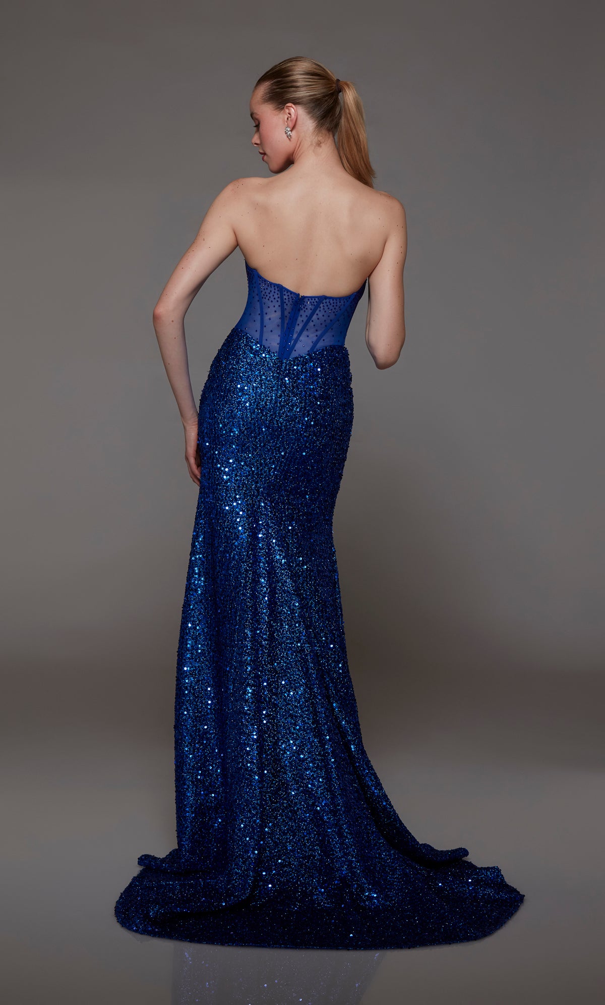 Captivating royal blue strapless prom dress with intricate sequin detailing, corset bodice with an zip up back, and an graceful train for an red-carpet-worthy look.