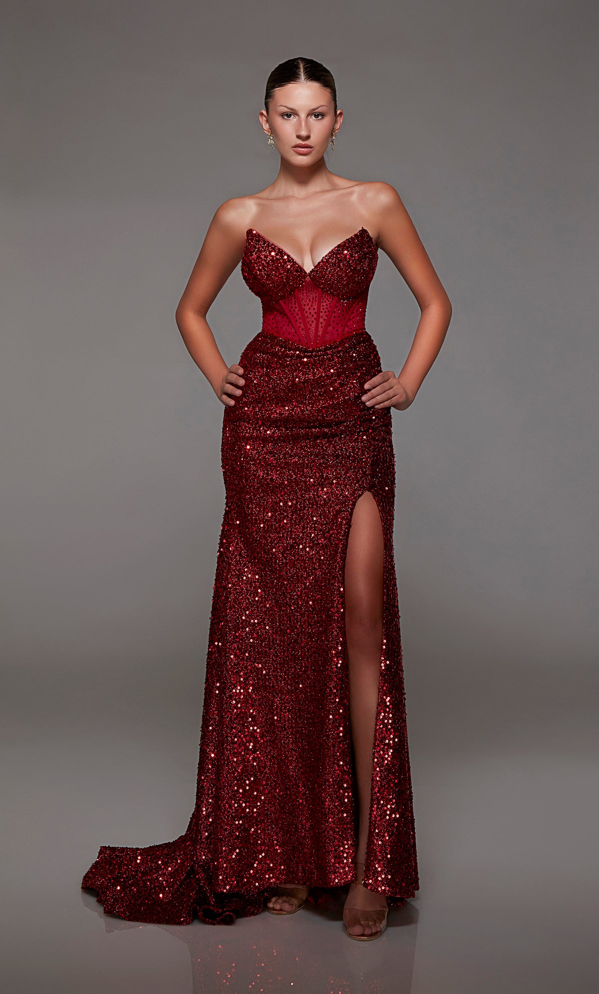 Captivating wine strapless prom dress with intricate sequin detailing, corset bodice, alluring slit, and an graceful train for an red-carpet-worthy look.