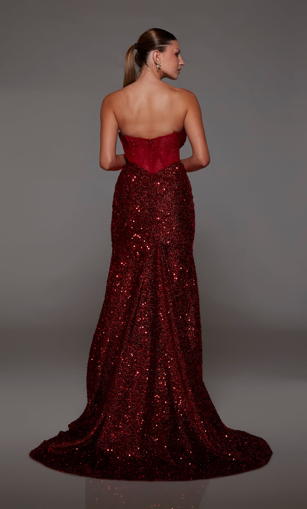 Captivating wine strapless prom dress with intricate sequin detailing, corset bodice with an zip up back, and an graceful train for an red-carpet-worthy look.