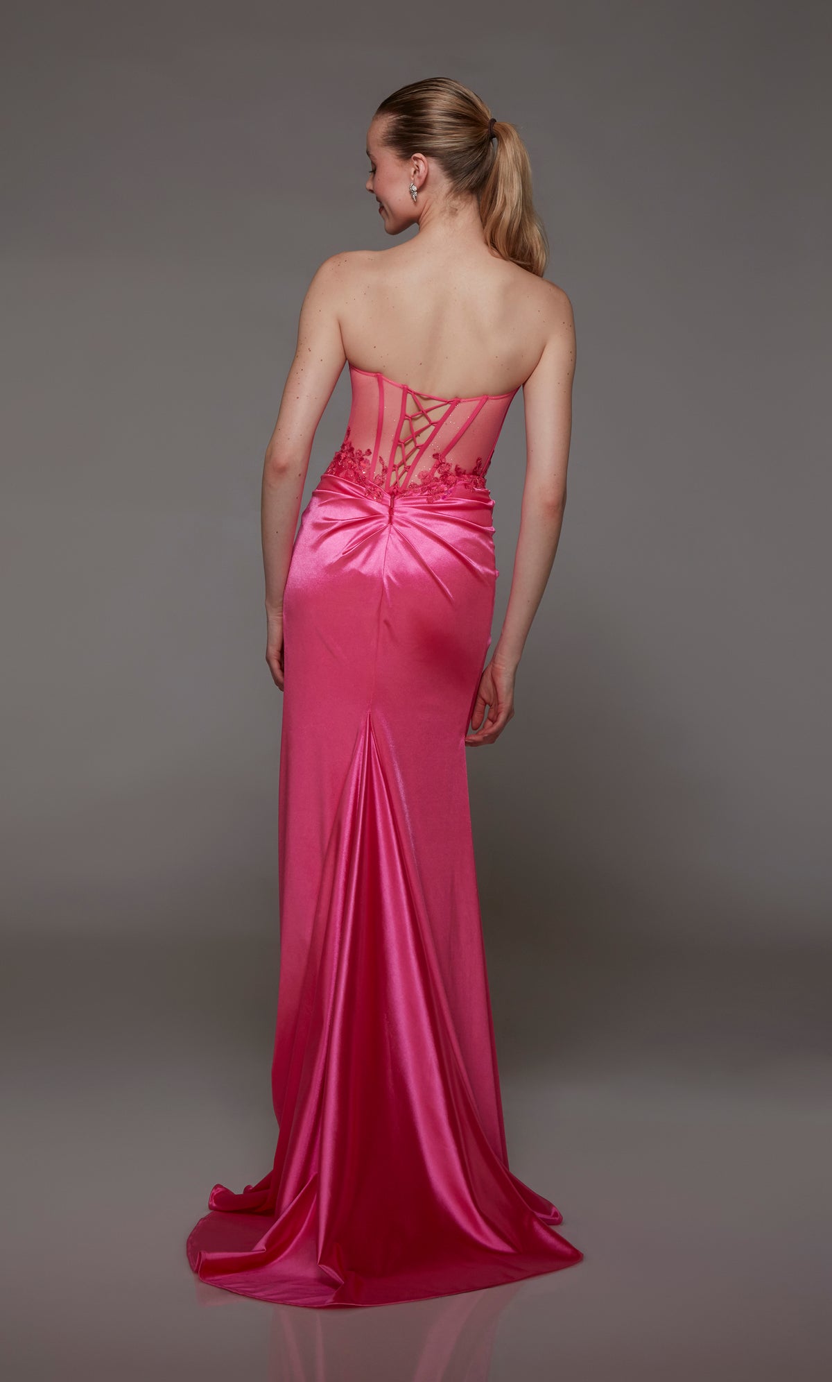 Neon pink corset prom dress: sheer bodice, ruching, high slit, lace-up back, train. Stretch satin with beaded lace accents for an dazzling look.