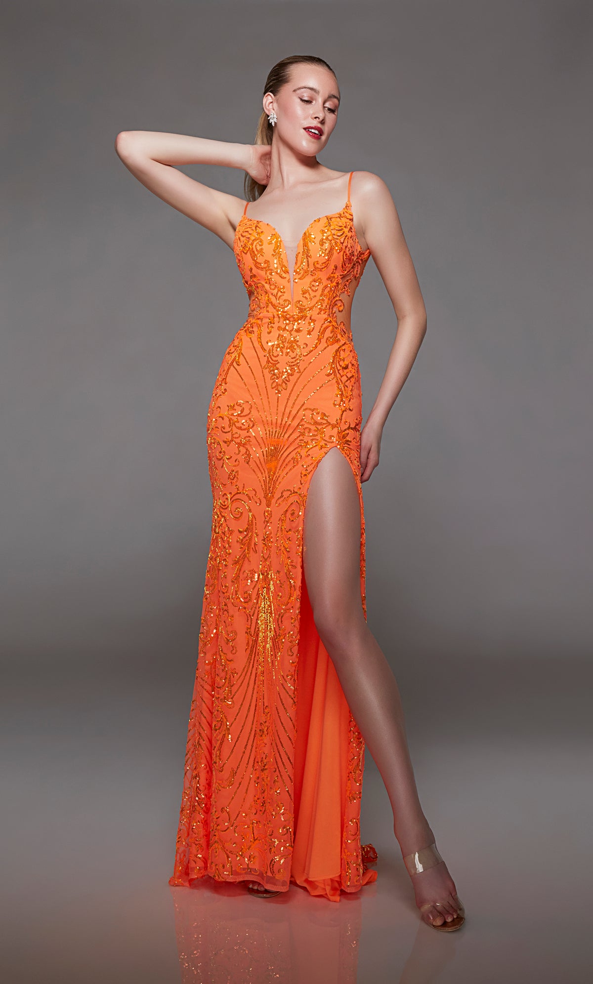 Bright orange sequin formal gown: plunging neckline, front slit, lace-up back, slight train. A stunning choice for an elegant and glamorous occasion.