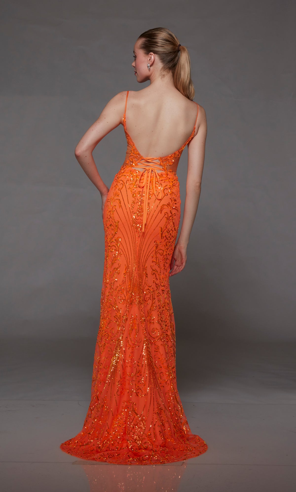 Bright orange sequin formal gown: plunging neckline, front slit, lace-up back, slight train. A stunning choice for an elegant and glamorous occasion.