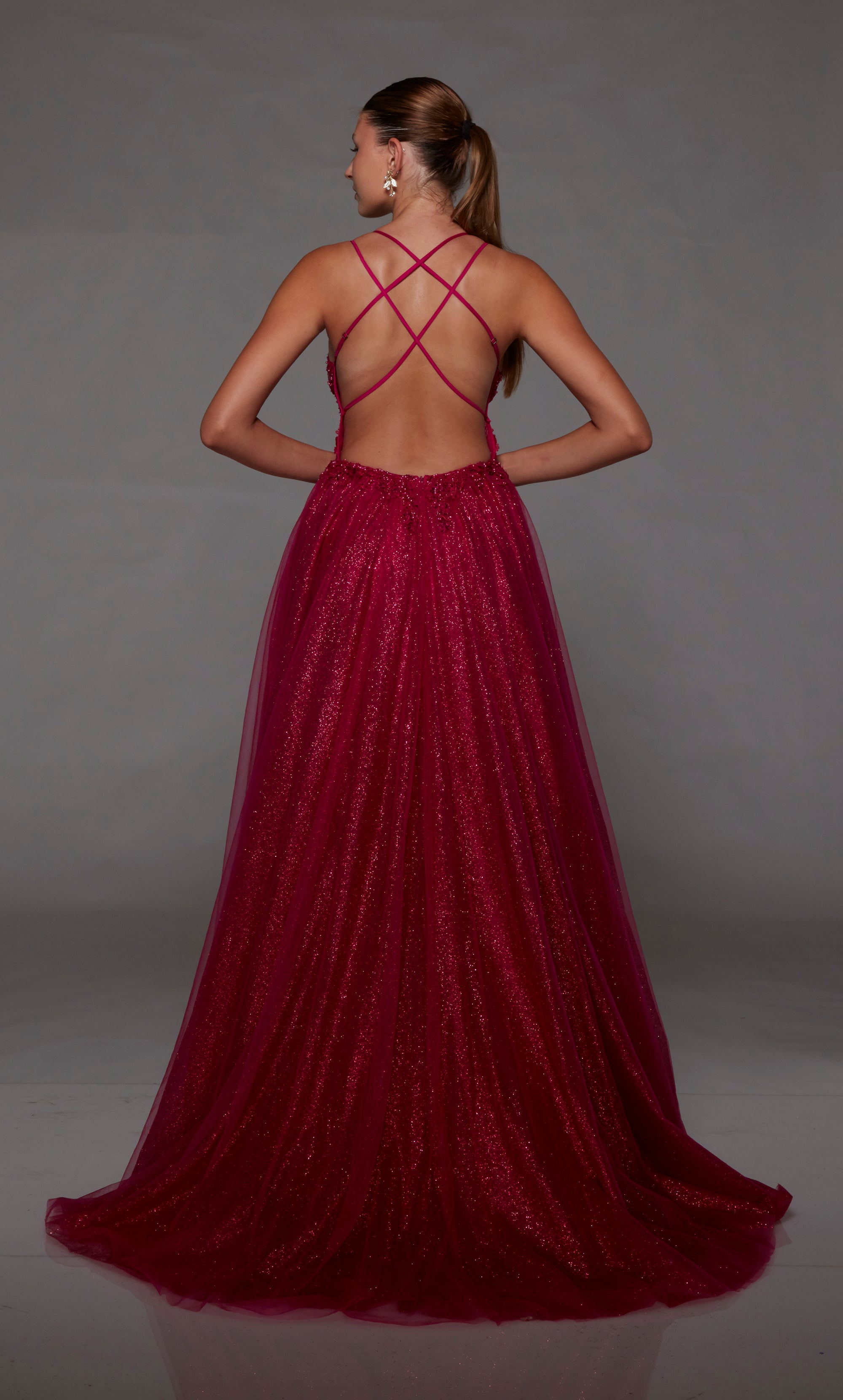 Fuchsia pink glitter tulle A-line prom dress: plunging V neckline, front slit, crisscross back straps, and train. A dazzling choice for an vibrant and stylish look.