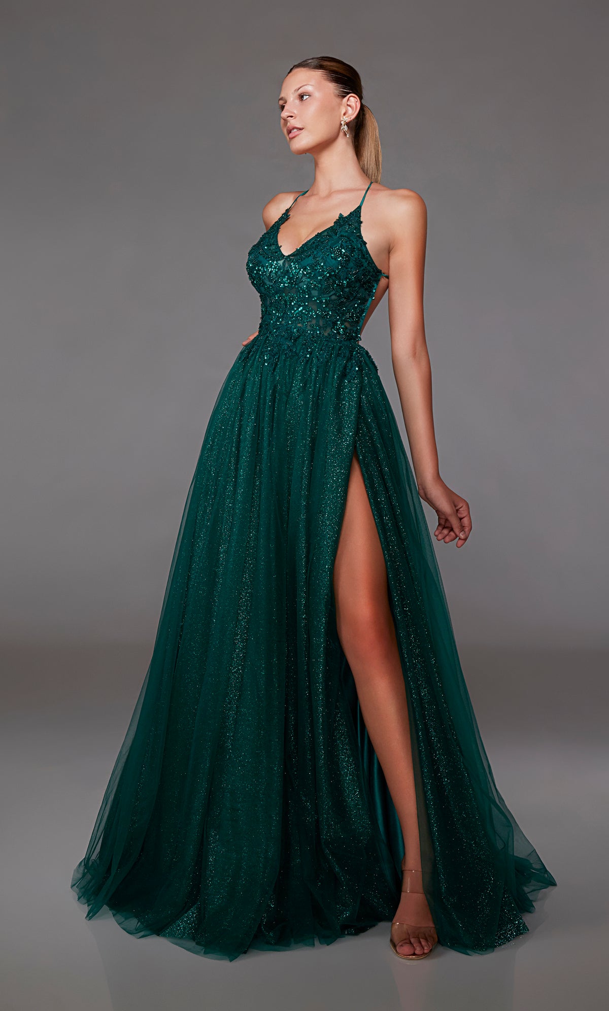Green glitter tulle A-line prom dress: plunging V neckline, front slit, crisscross back straps, and train. A dazzling choice for an vibrant and stylish look.