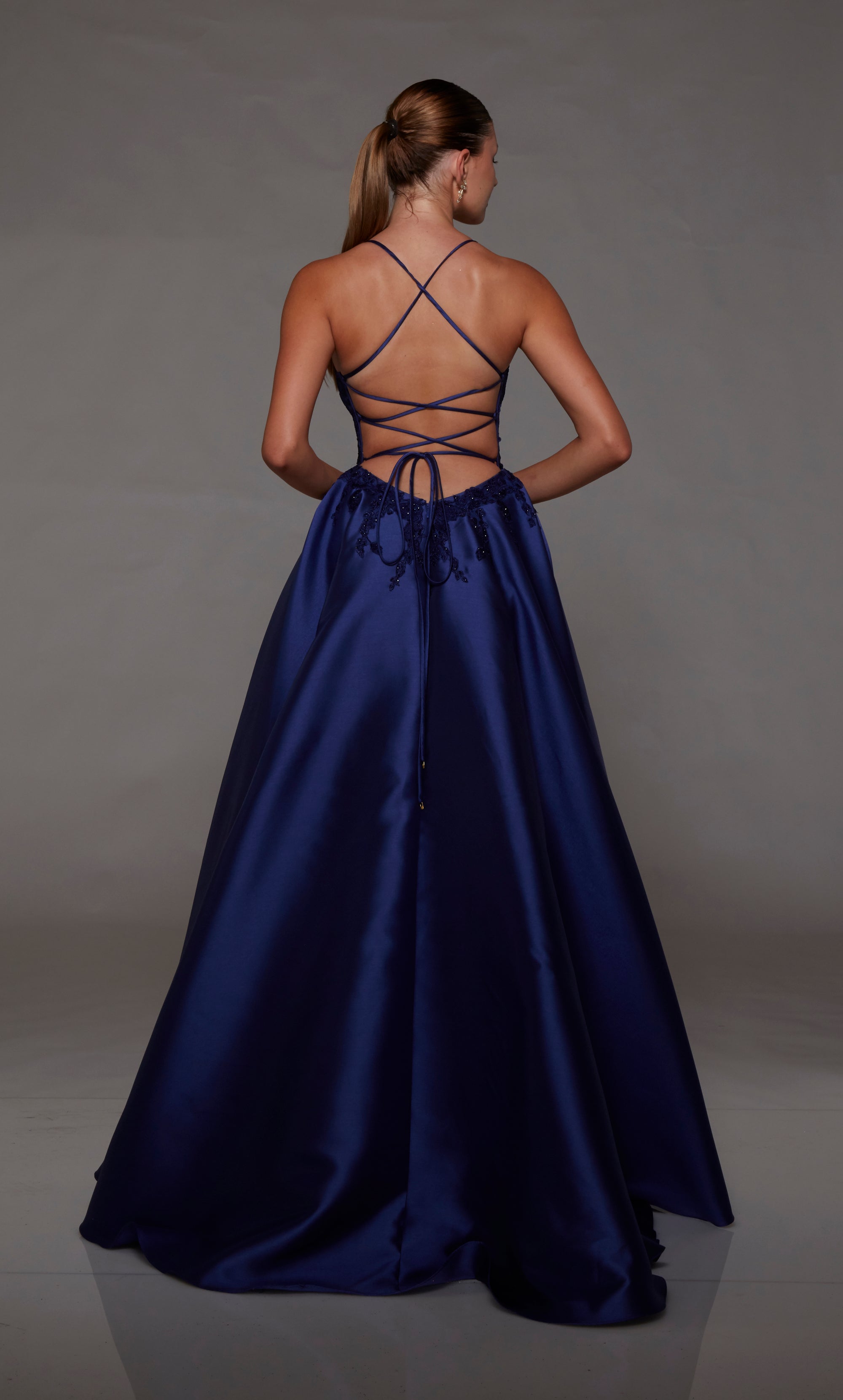 Navy mikado ball gown with lace corset, strappy back, and slight train for an stylish and vibrant look.