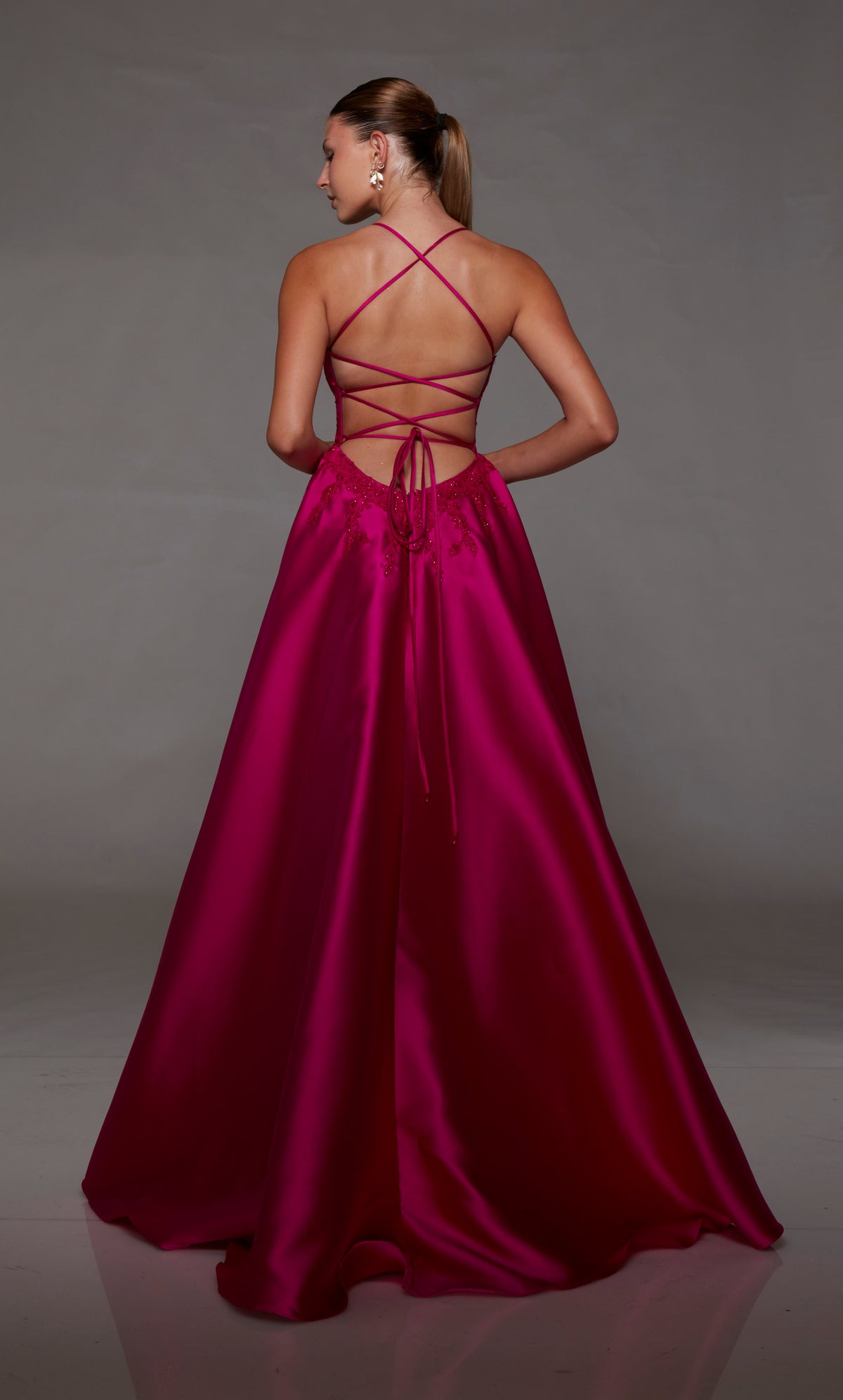 Pink mikado ball gown with lace corset, strappy back, and slight train for an stylish and vibrant look.