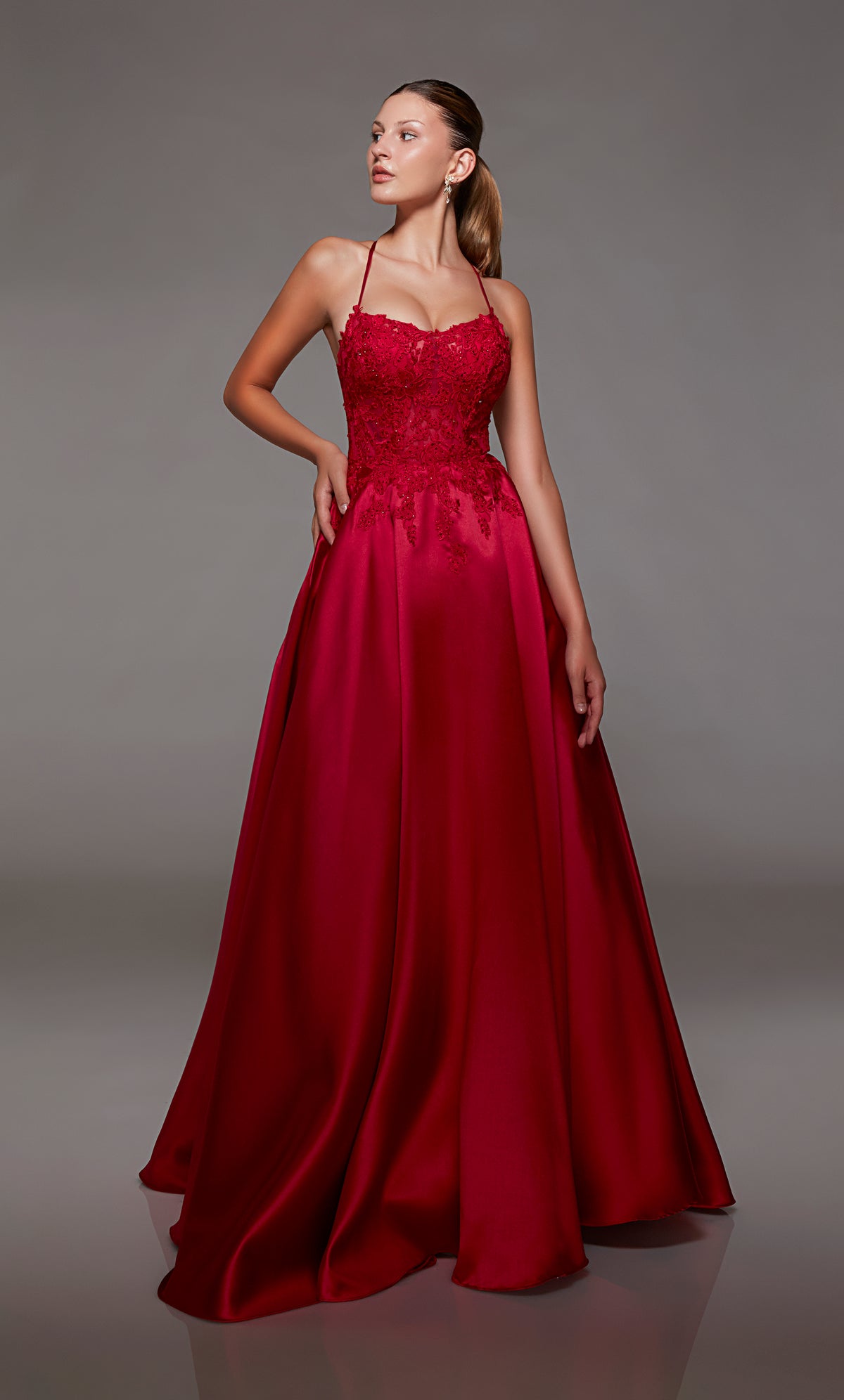 Red mikado ball gown with lace corset, strappy back, and slight train for an stylish and vibrant look.