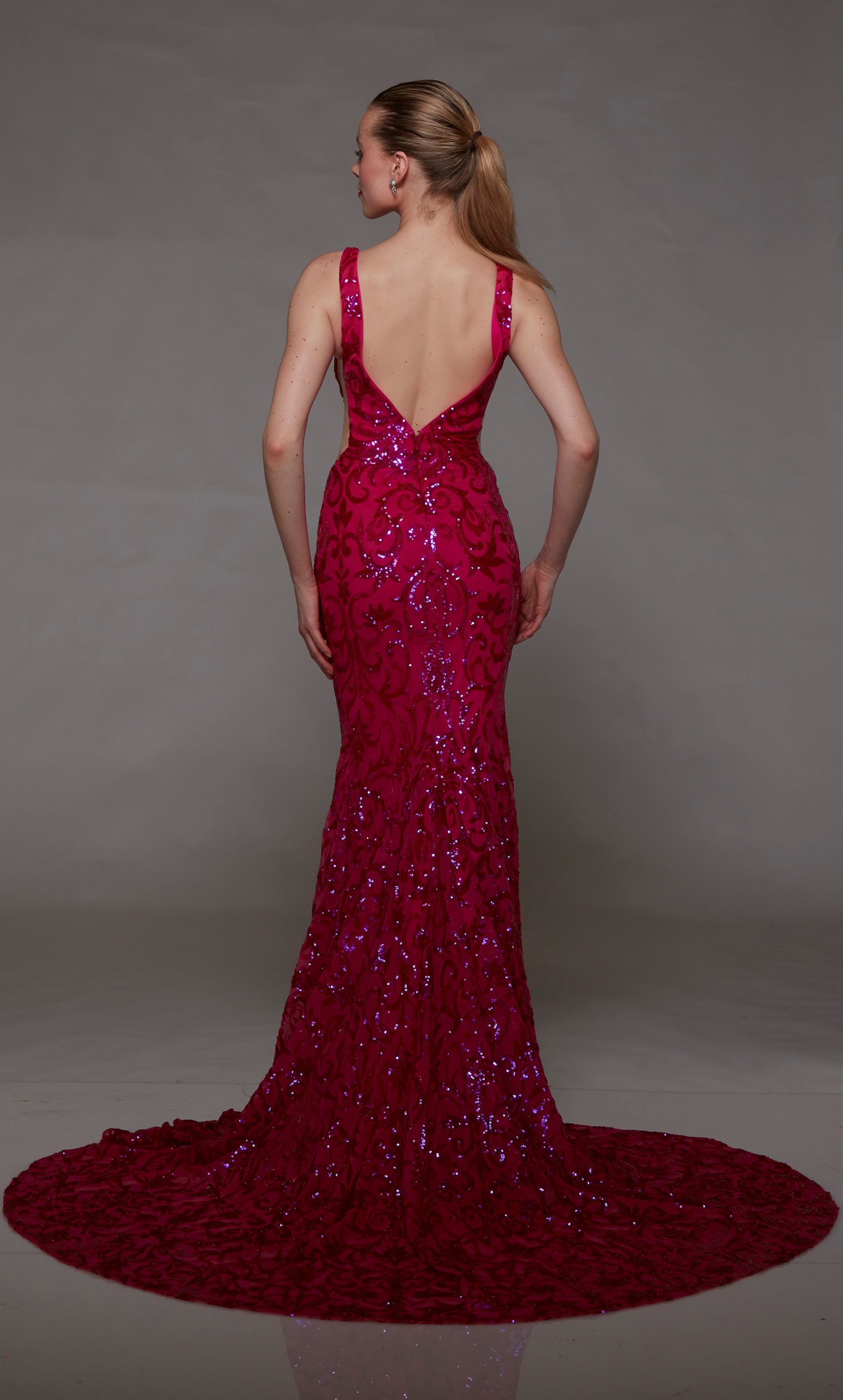 Chic formal gown with an plunging neckline and delicate sequin embellishments in captivating raspberry pink color.