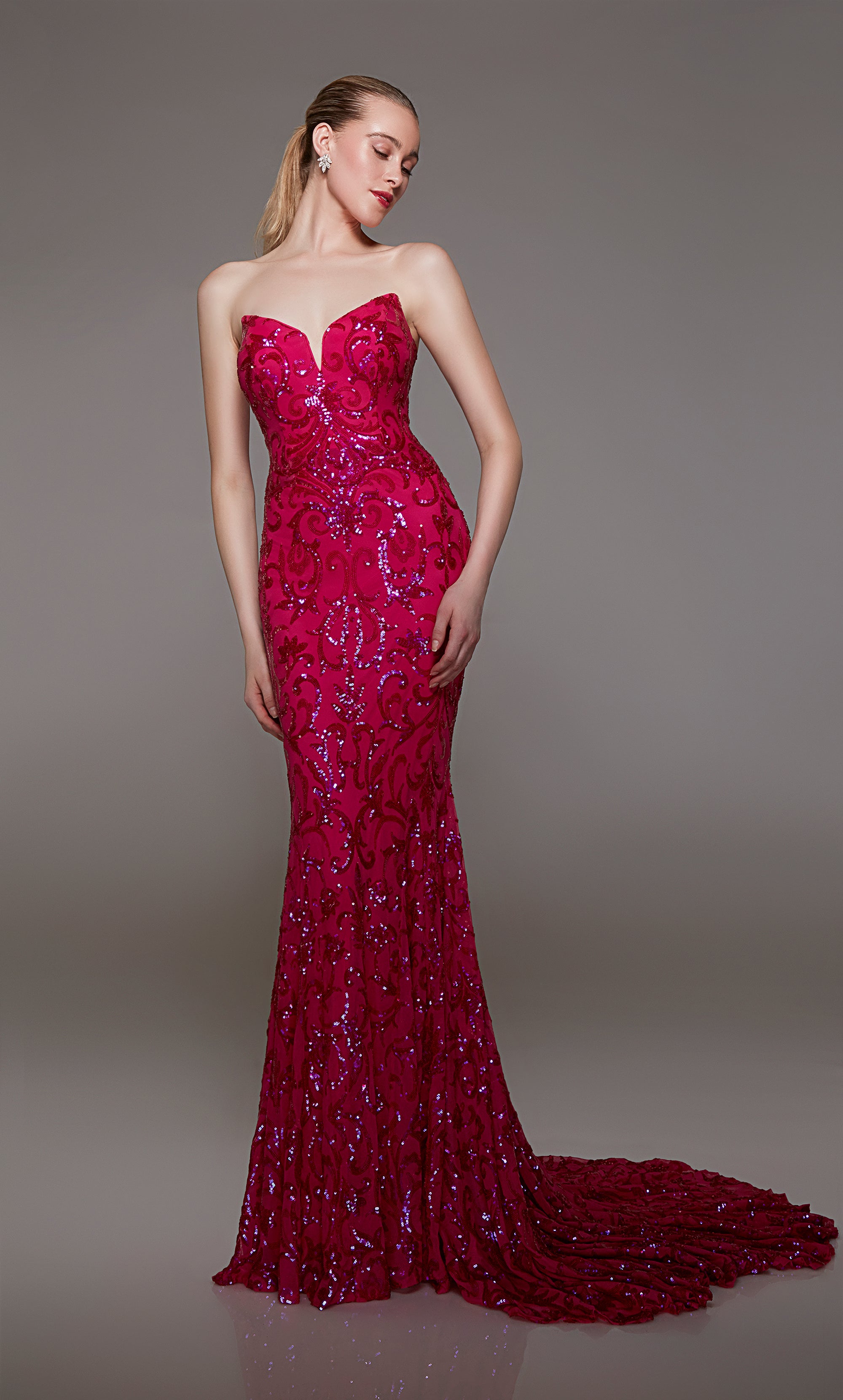 Pink strapless designer dress adorned with delicate sequin embellishments, featuring an lace-up back and an long glamorous train for an truly elegant look.