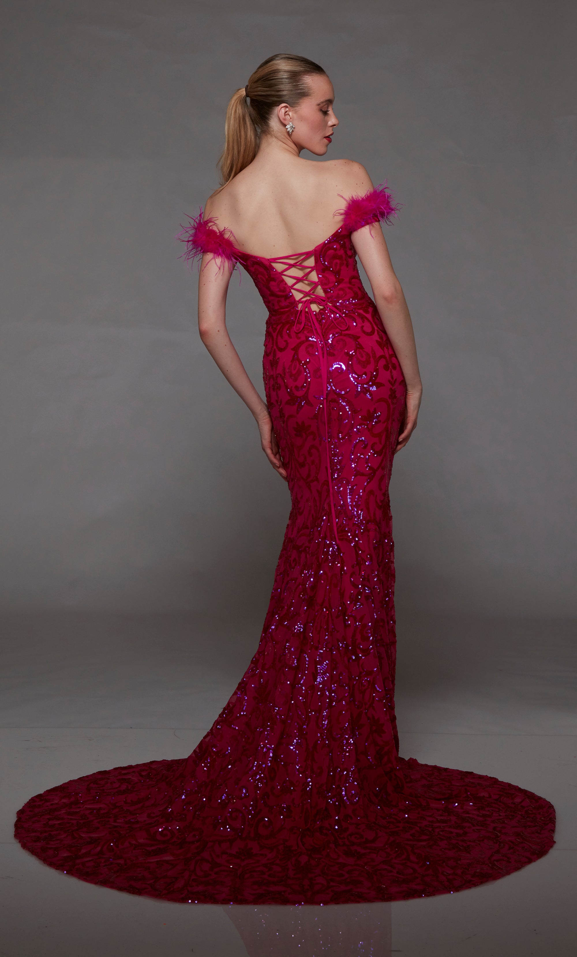 Pink off-shoulder designer dress: sequin embellishments, feather trim, lace-up back, and an glamorous train for elegant allure.