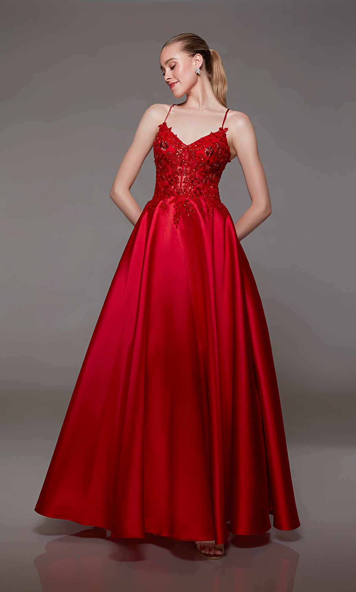 Red corset ball gown: V-neckline, sheer floral lace bodice, full mikado skirt, lace-up back for an captivating and timeless look.