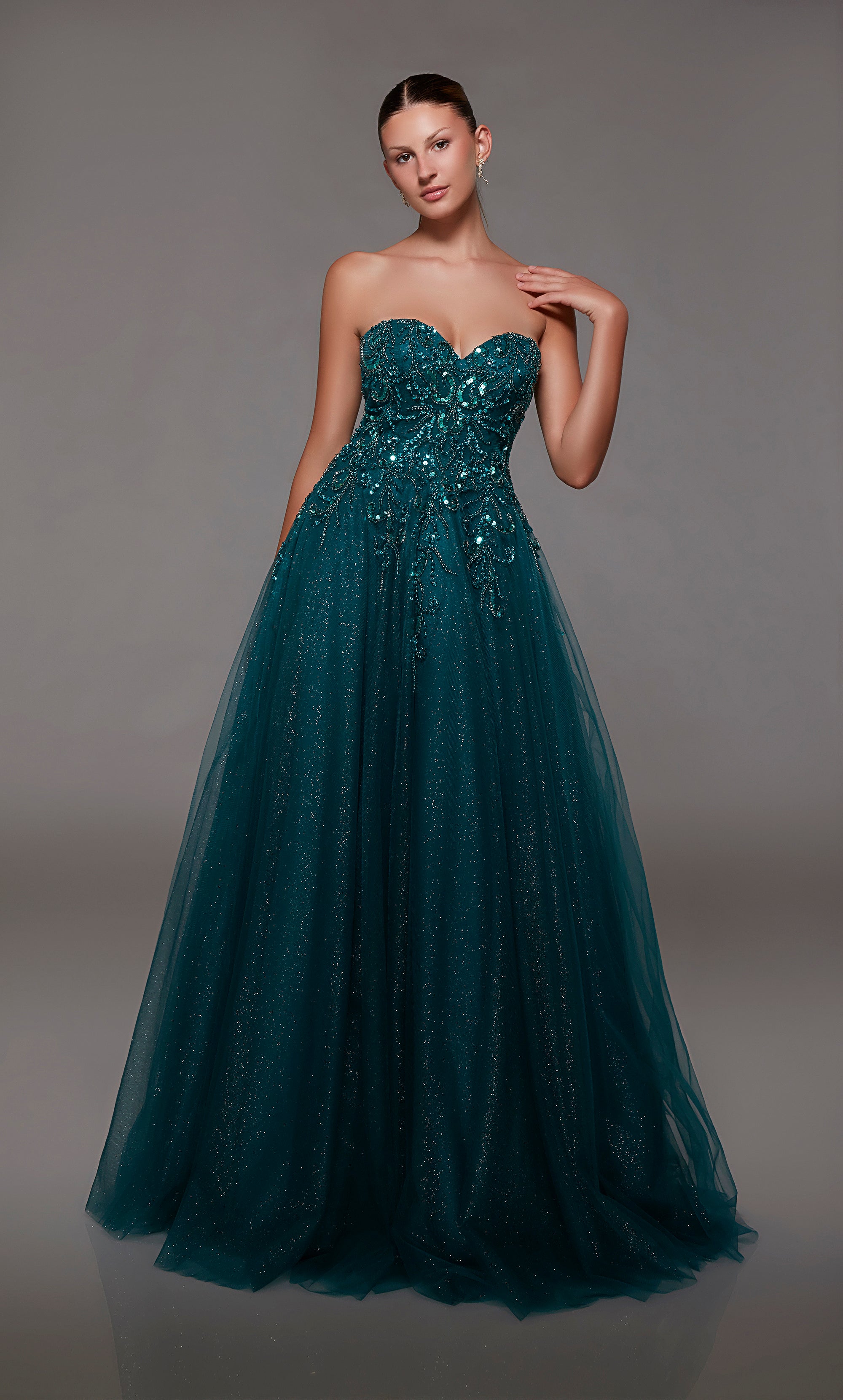 Enchanting green sweetheart ball gown with an lace-up back, sequined lace appliques on the bodice, and glitter tulle fabrication for timeless elegance.