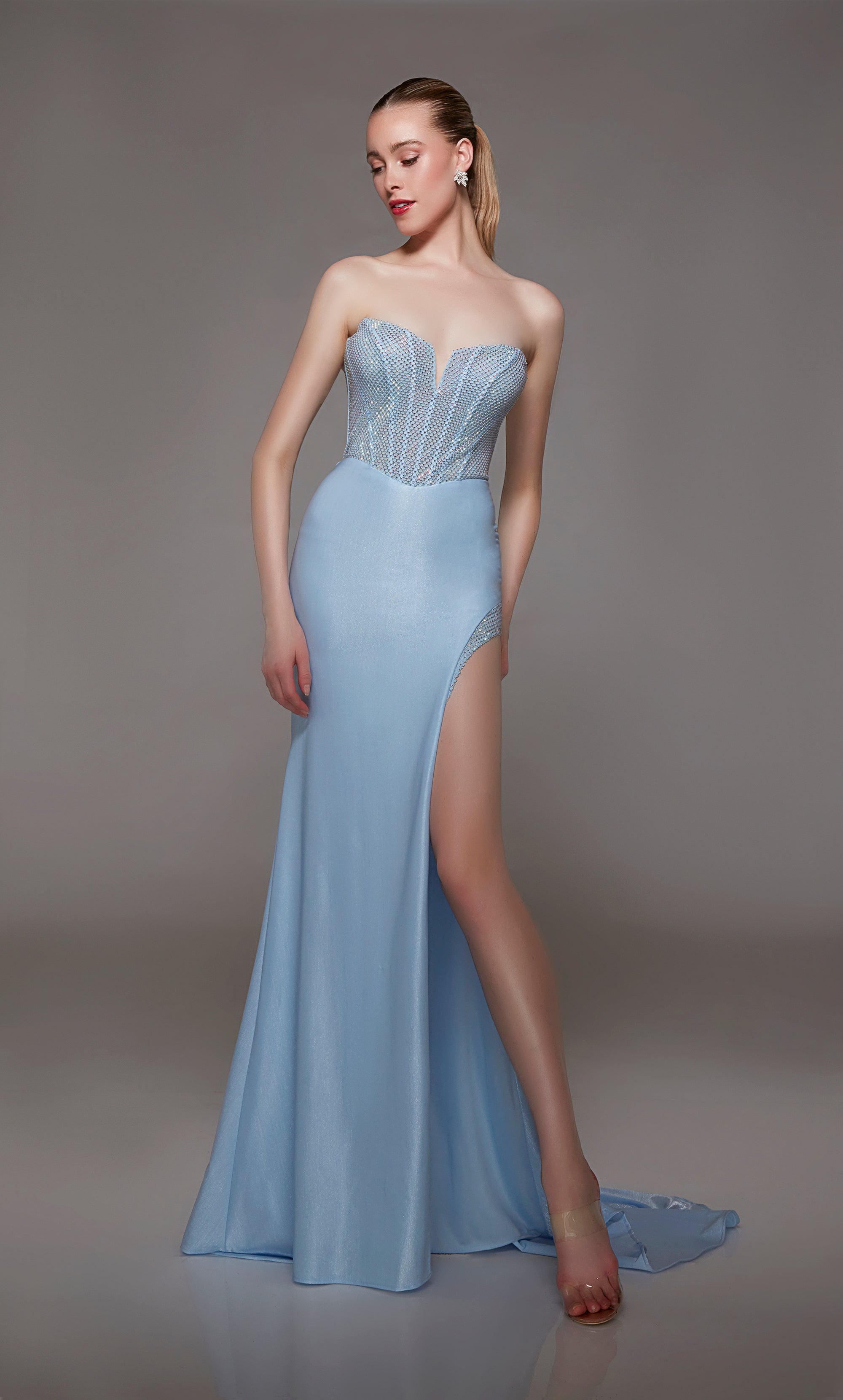 Glacier blue strapless prom dress: Shimmery hotfix rhinestone-adorned corset top, metallic stretch jersey skirt with daring side slit and train, zip-up back for an glamorous look.