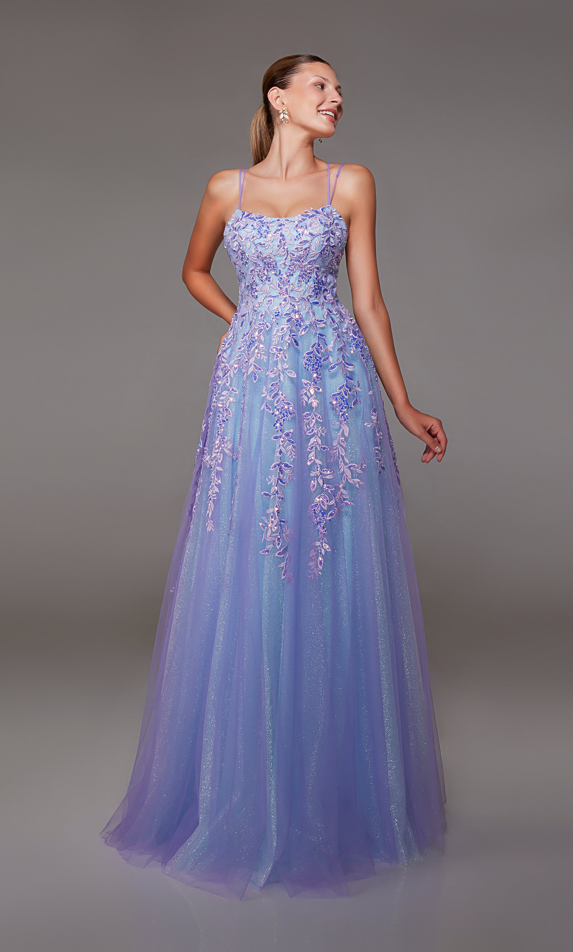 Purple-light blue glitter tulle A-line prom dress featuring an slightly scooped neckline, beaded floral lace appliques, and an lace up back closure for the perfect fit!
