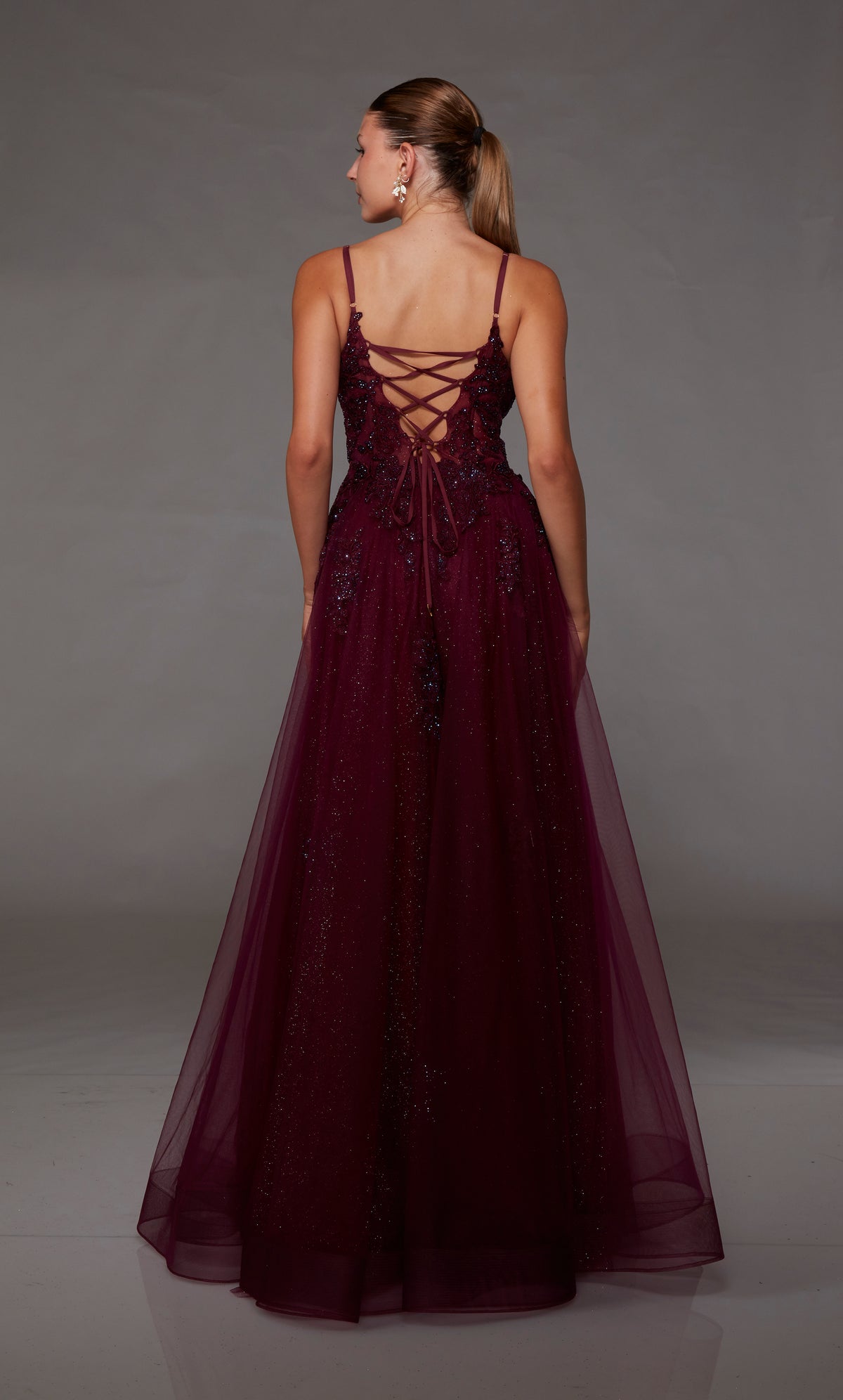 Dark red prom dress with an A-line silhouette, plunging neckline, beaded floral lace appliques, and an lace up back closure for the perfect fit!