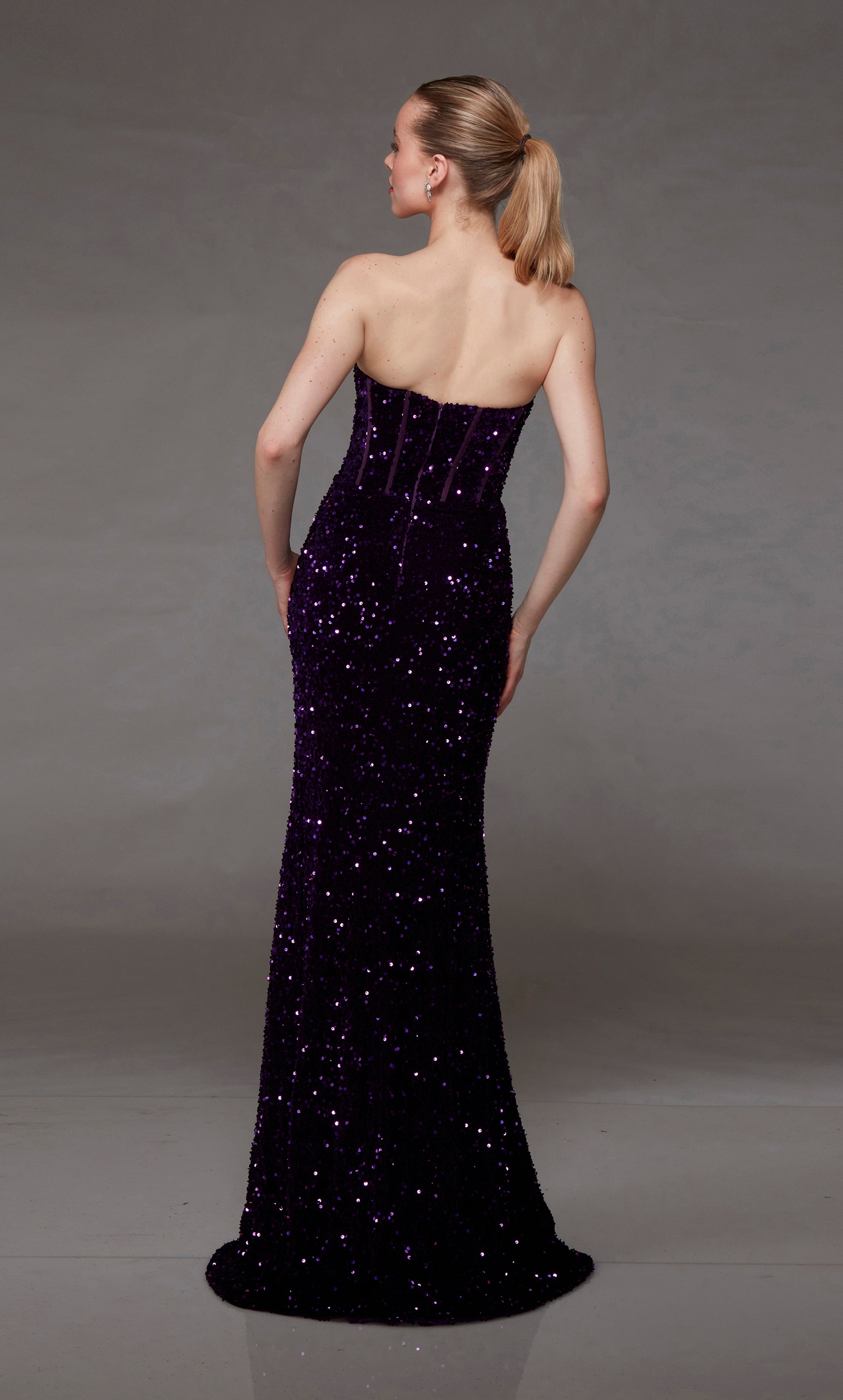 Purple sequin prom dress: Strapless corset top, side slit, and slight train for an chic and modern aesthetic.