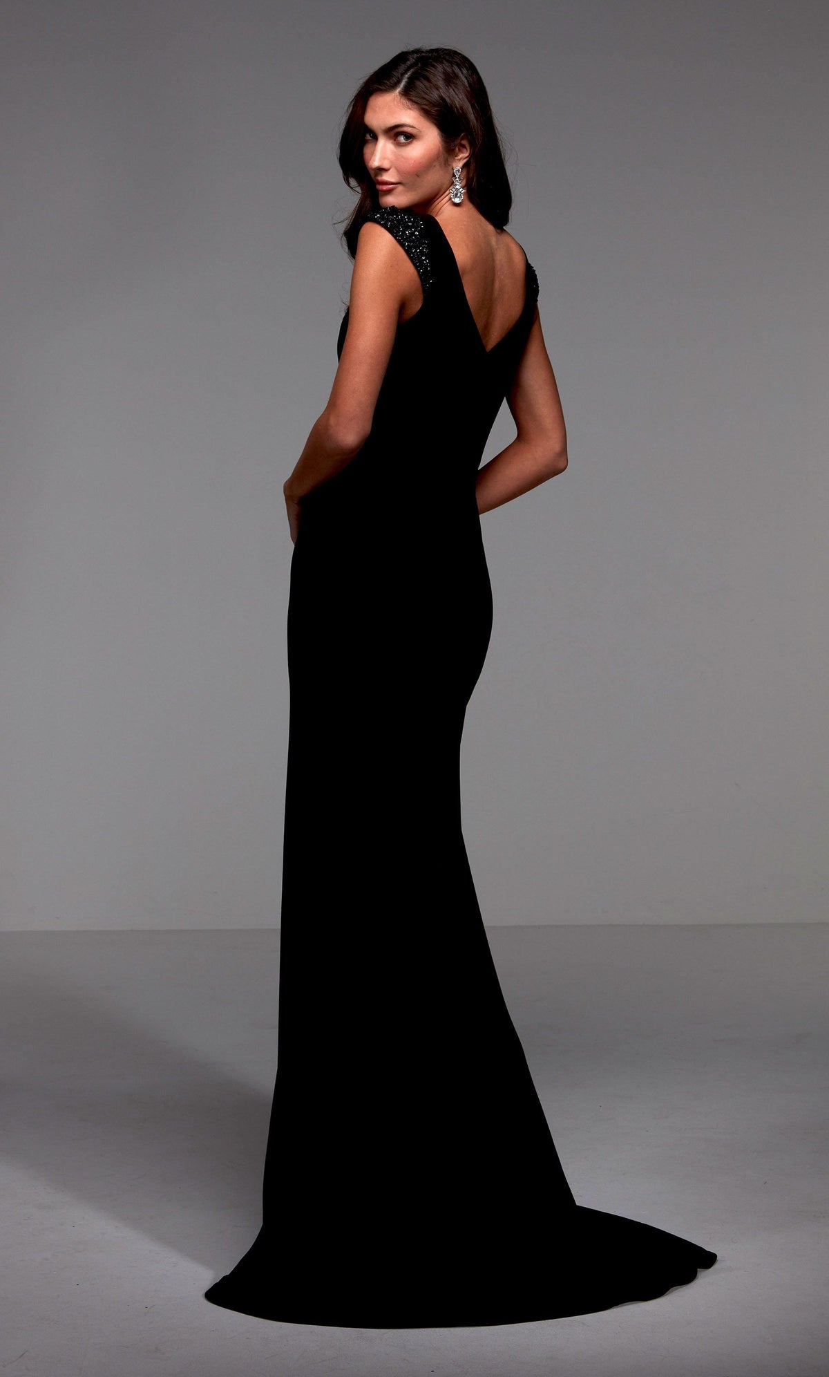 Black long evening dress with beaded capped sleeves, a V shaped back, and train