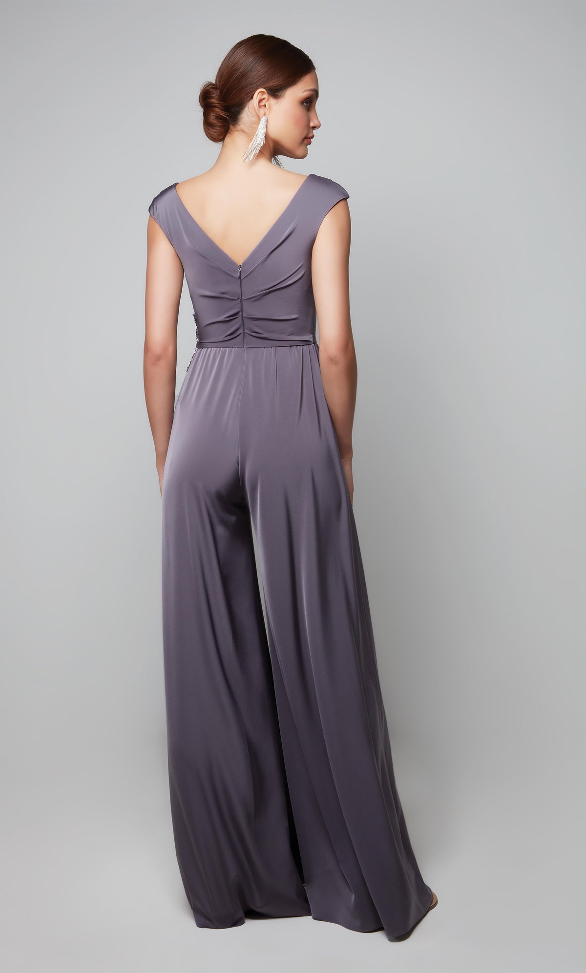Elegant wide leg jumpsuit with cap sleeves and lace applique at the waist in graphite.