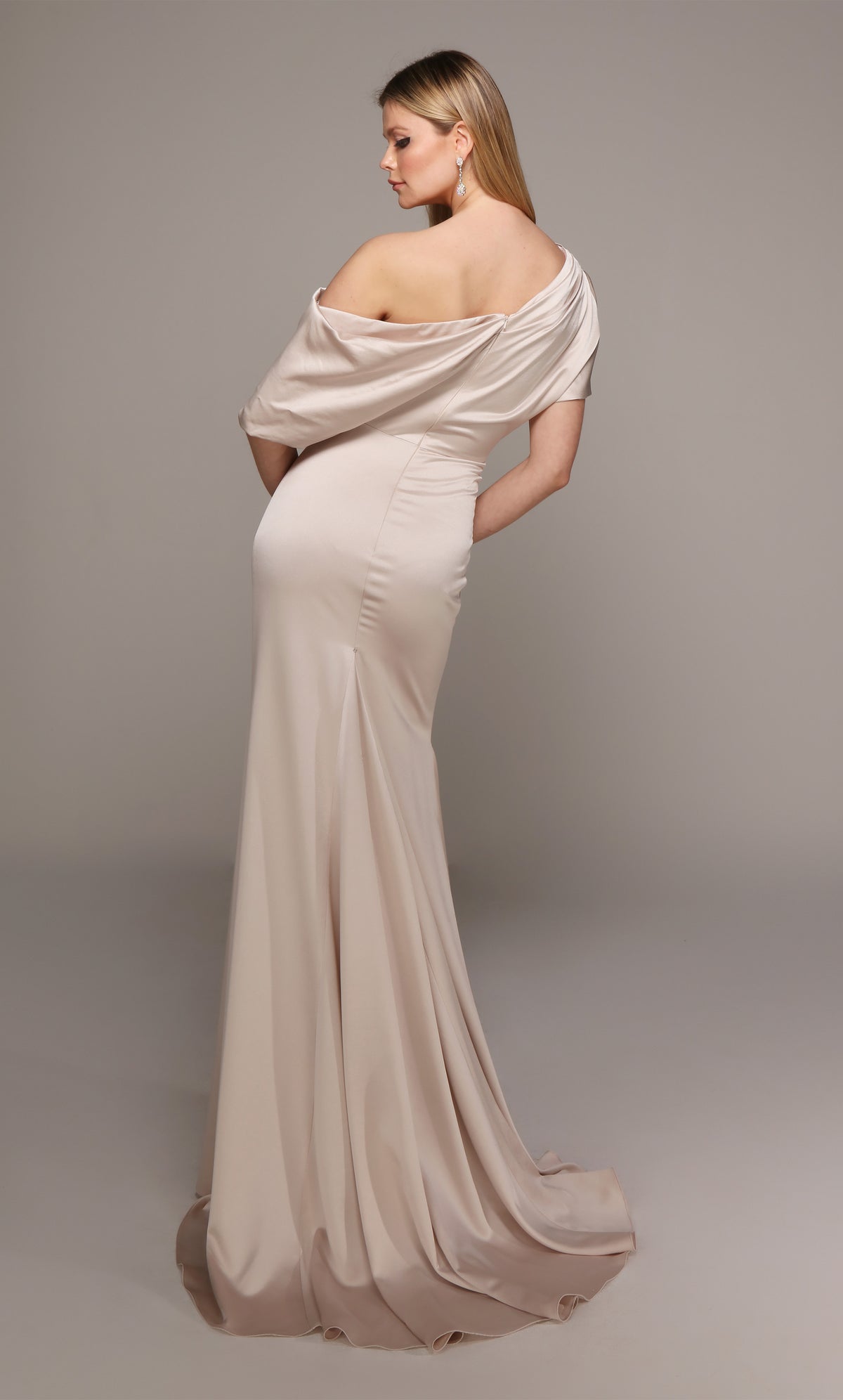 One shoulder drape dress with a closed back and train in creme color.