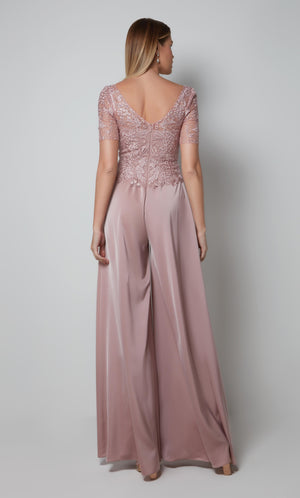 Light pink wide leg jumpsuit with a V shaped back and short sleeve lace bodice.