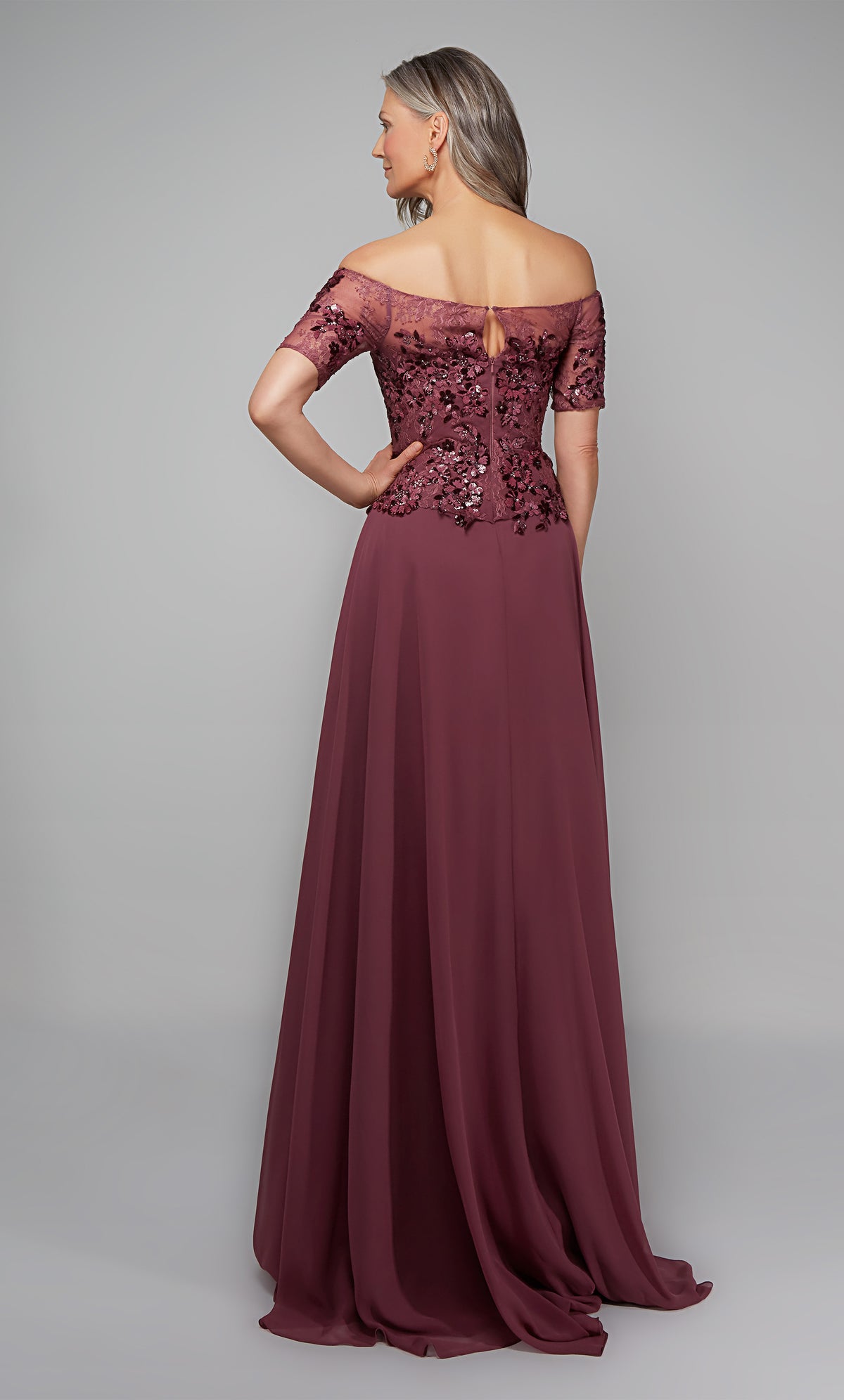Off the shoulder chiffon formal dress with floral appliques and a train in purple.
