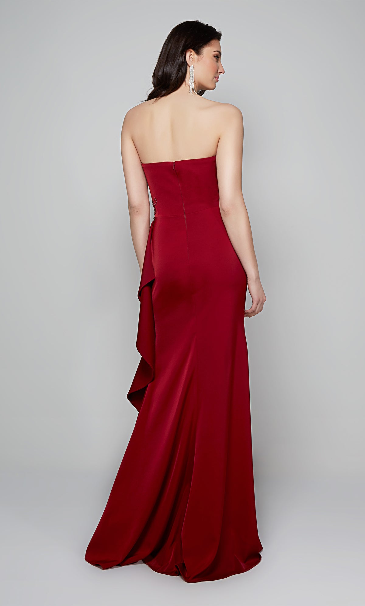 Long strapless fit and flare gown with a side ruffle and zip up back in claret.