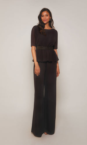 Peplum jumpsuit with short sleeves, an faux beaded belt at the waistline, and wide leg pant in charcoal. Color-SWATCH_27576__CHARCOAL