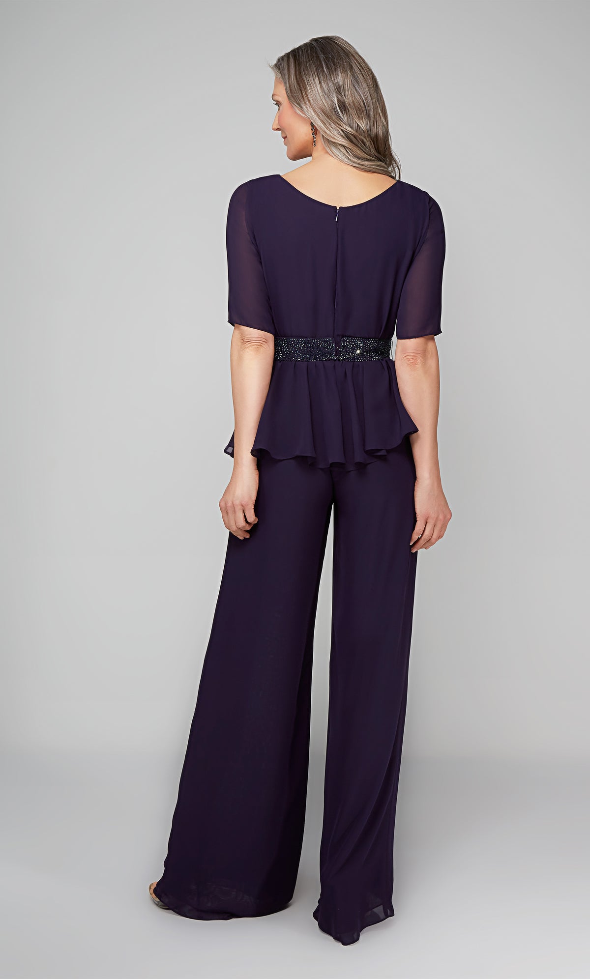 Formal jumpsuit with short sleeves and a faux beaded belt at the waist.