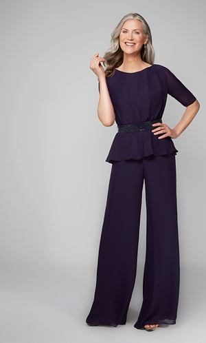 Elegant wide leg jumpsuit with short sleeves and a faux beaded belt at the waist.