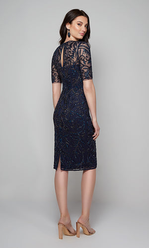 Embellished midi dress with short sleeves, a zip up back, and a back slit in midnight blue.