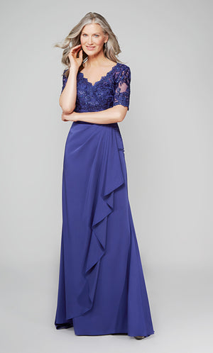 Long navy mother of the bride dress with a lace bodice, scalloped V neckline, faux belt at the natural waist, and short sleeves.