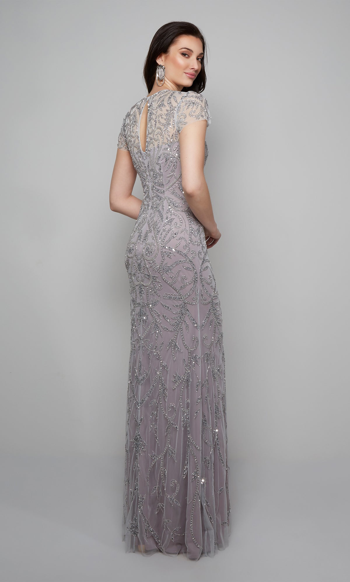 Floor length beaded evening gown with a keyhole back and short sleeves in lilac.