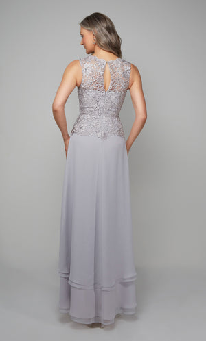 Flowy chiffon formal dress with a lace bodice, keyhole back detail, and tiered skirt in silver.