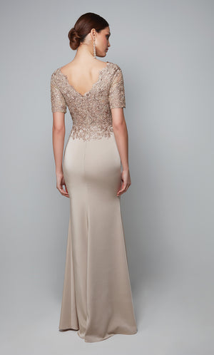 Stretch crepe formal gown with a V shaped back, sleeves, and a lace bodice in light tan color.